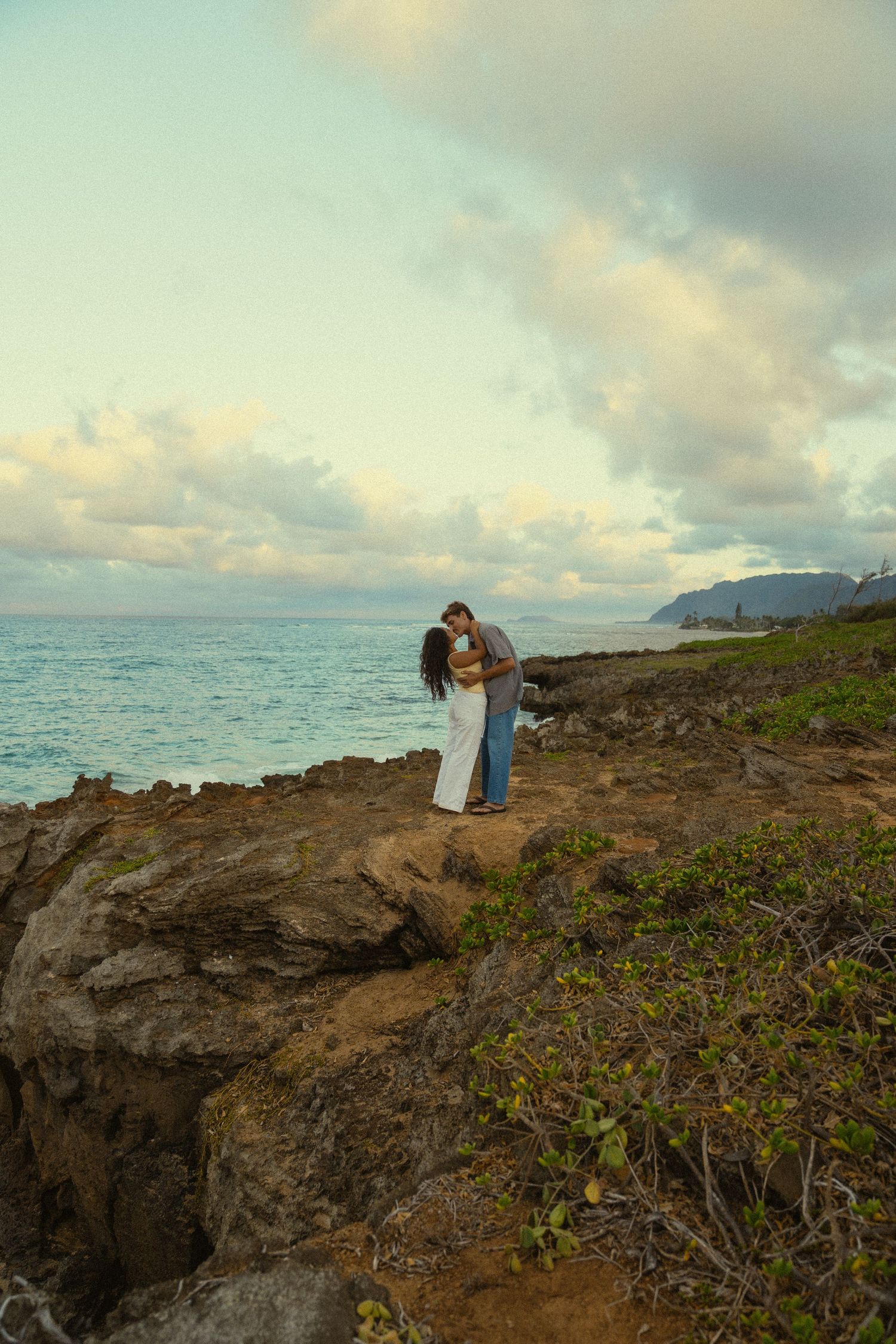 Dramatic coastal landscape with volcanic rocks and ocean views at dusk.