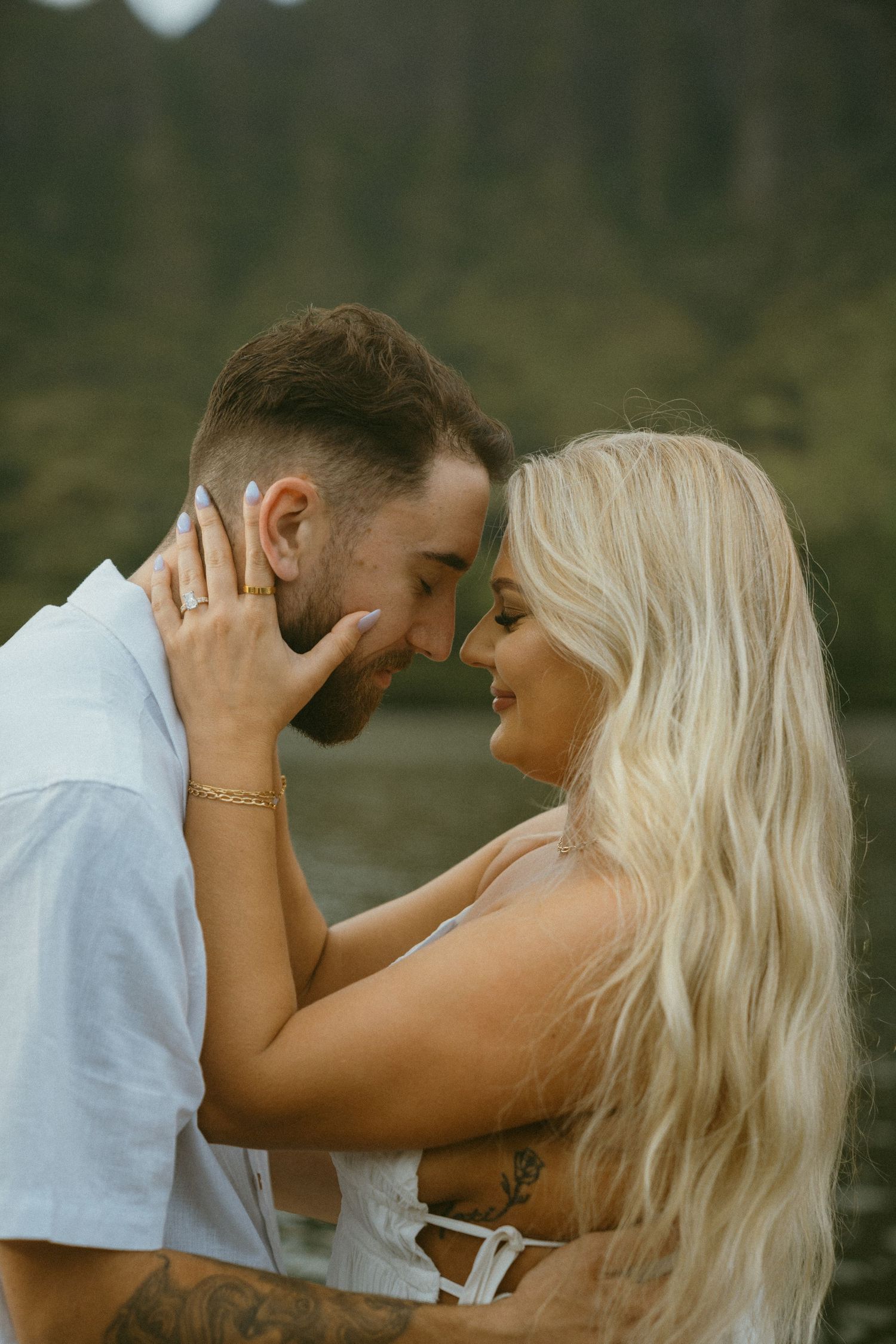 Intimate moment captured against scenic mountain lake backdrop.