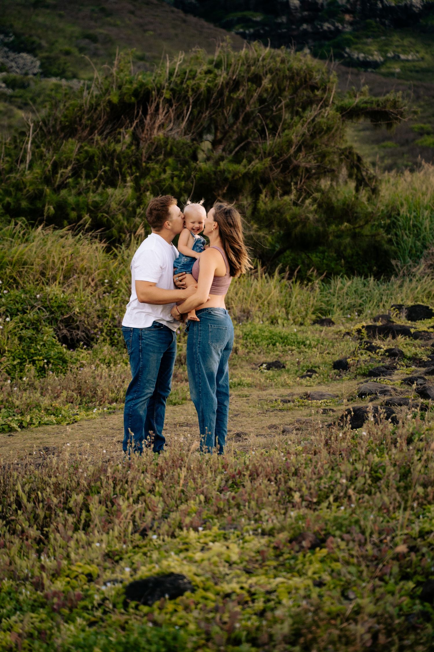 Couple sharing romantic moments on a mountain trail during golden hour.