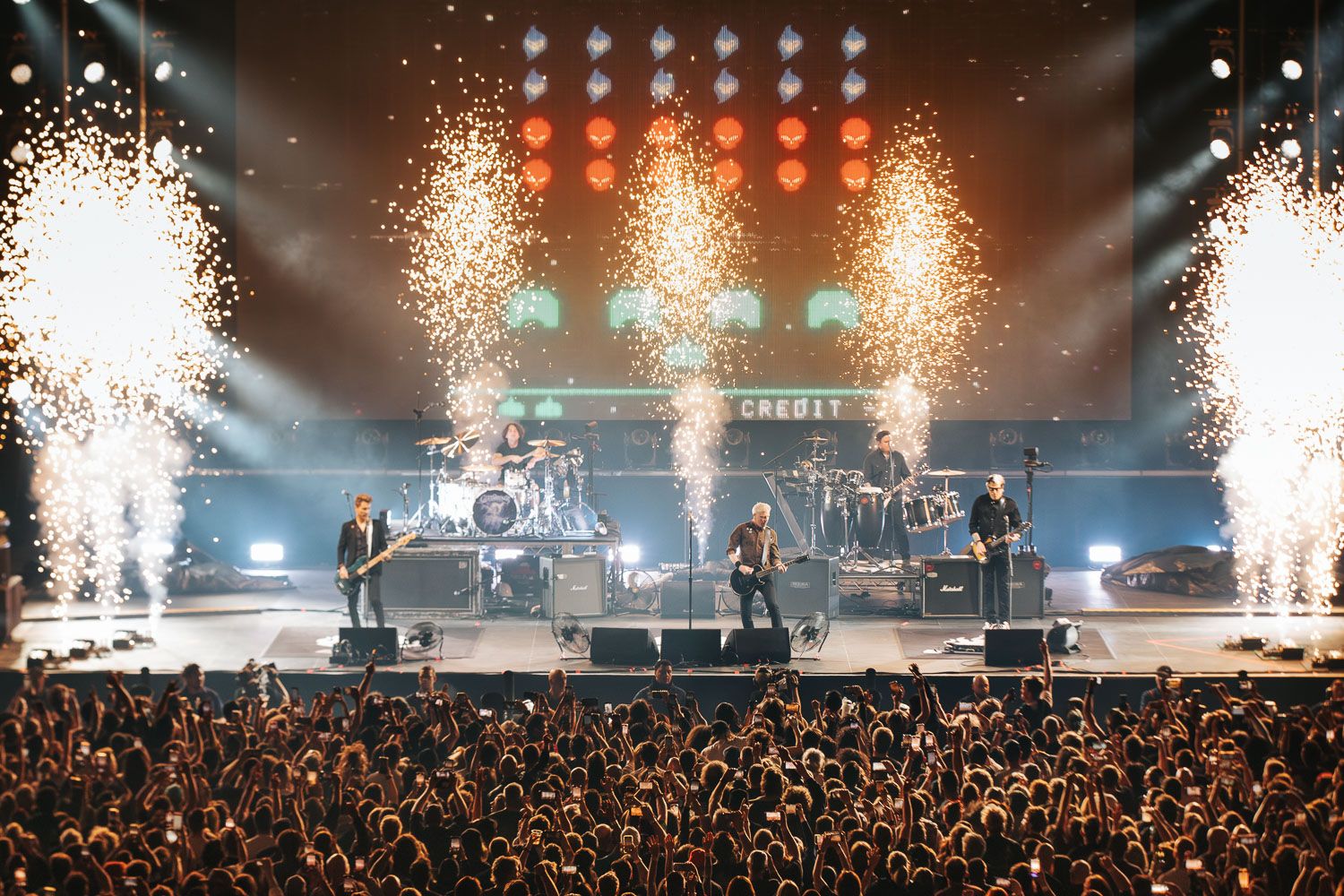 The Offspring performing live on a massive stage with pyrotechnics and fireworks at a Melbourne live music event.