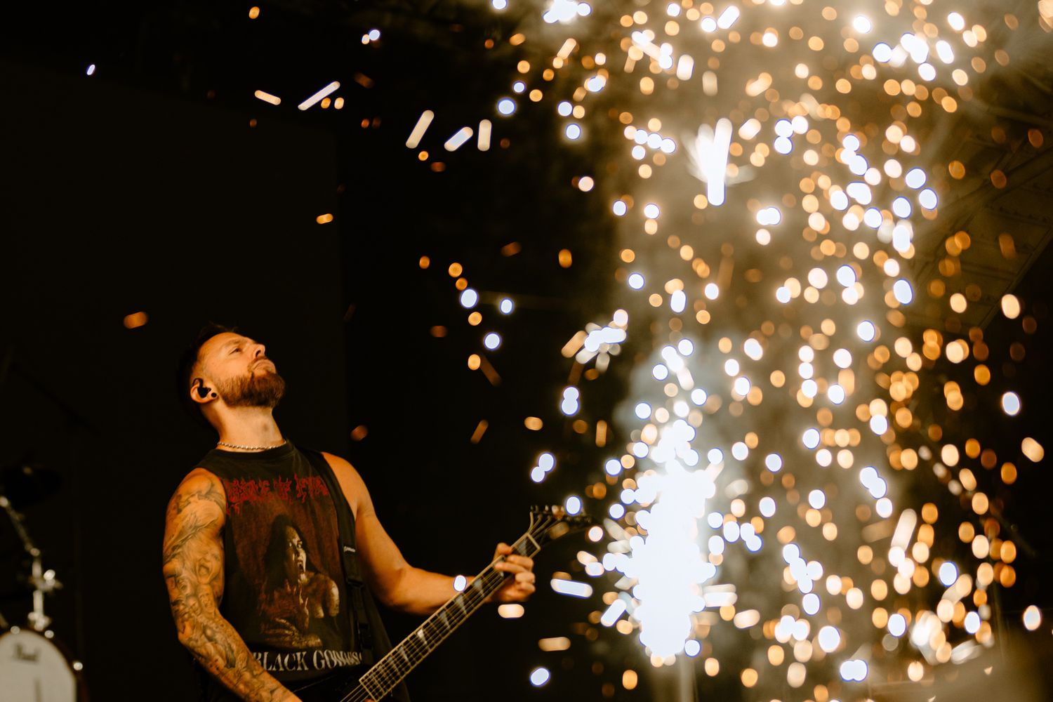 Bullet For My Valentine guitarist performing on stage with gold pyrotechnic sparks, captured by a Melbourne music photographer.