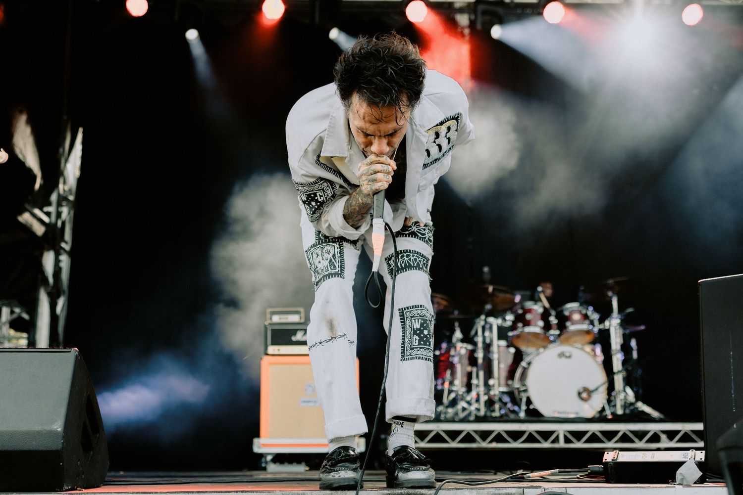 Fever 333 frontman Jason Aalon performing on stage in a white patched outfit with smoke and red stage lighting, Melbourne photography.