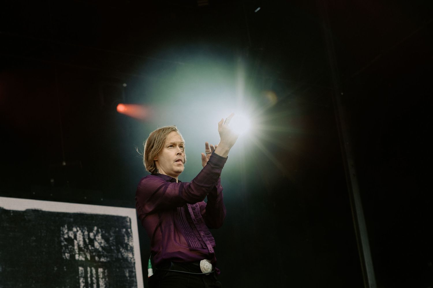 Refused vocalist Dennis Lyxzén in a purple shirt performing under a bright spotlight, Good Things festival live music photography Melbourne.