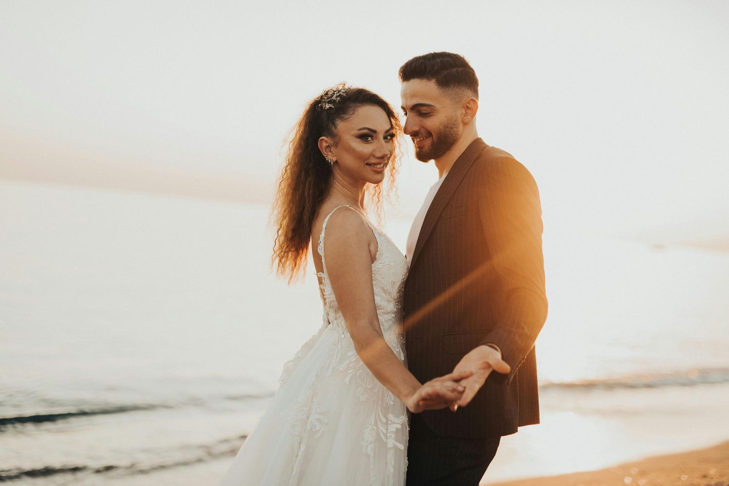 A couple shares a romantic moment on the beach during golden hour sunset. Trusted Sedona Photographer.