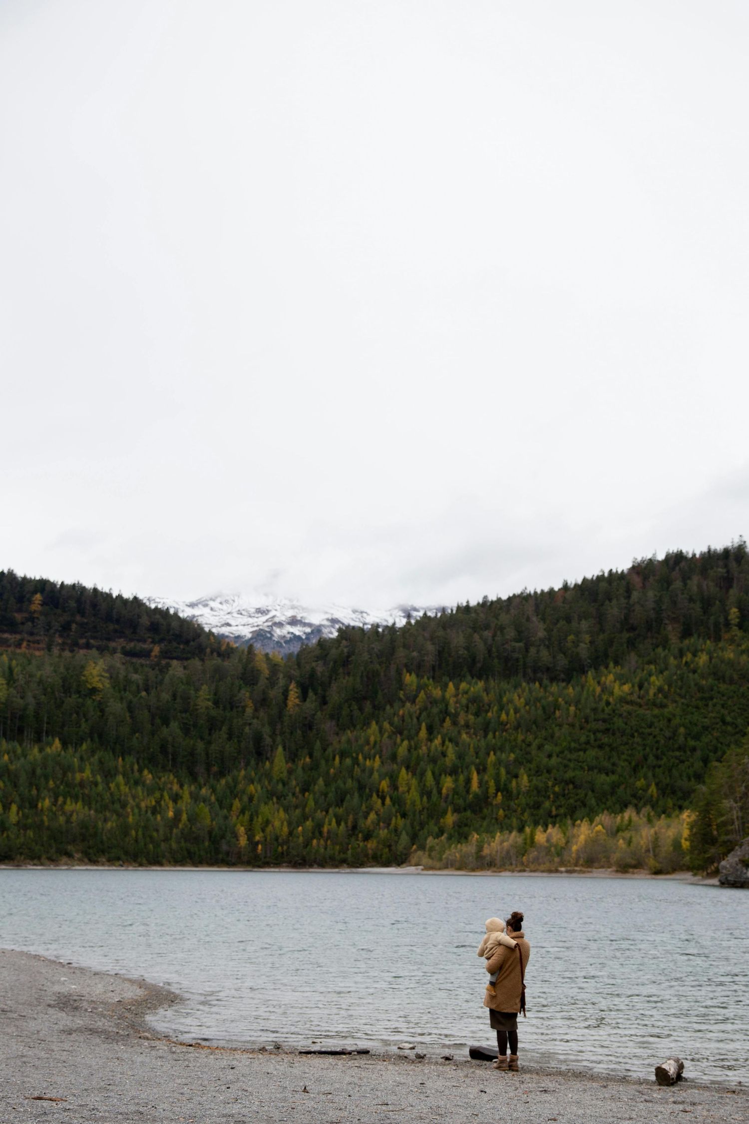 Sedona Arizona Portraits Mountain lake landscape with evergreen forests and snow-capped peaks in distance.