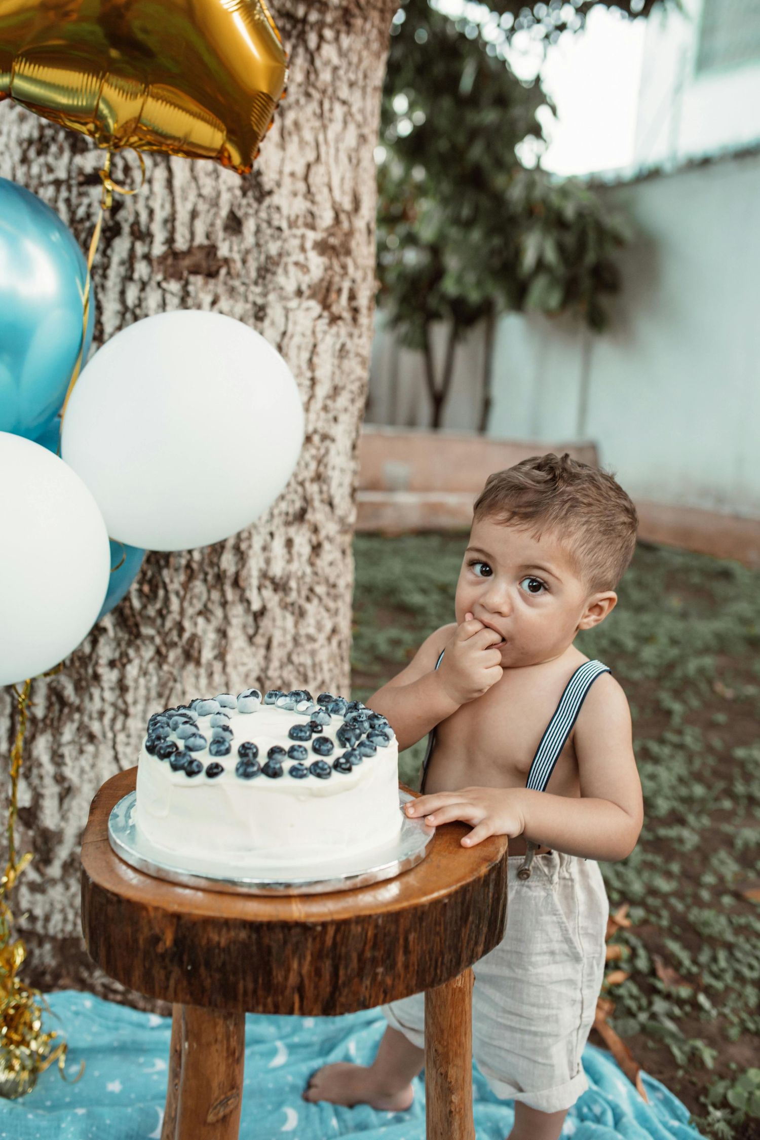 Mesa playful smash cake portrait, child enjoying birthday, warm natural light, photographed by top Arizona photographer.
