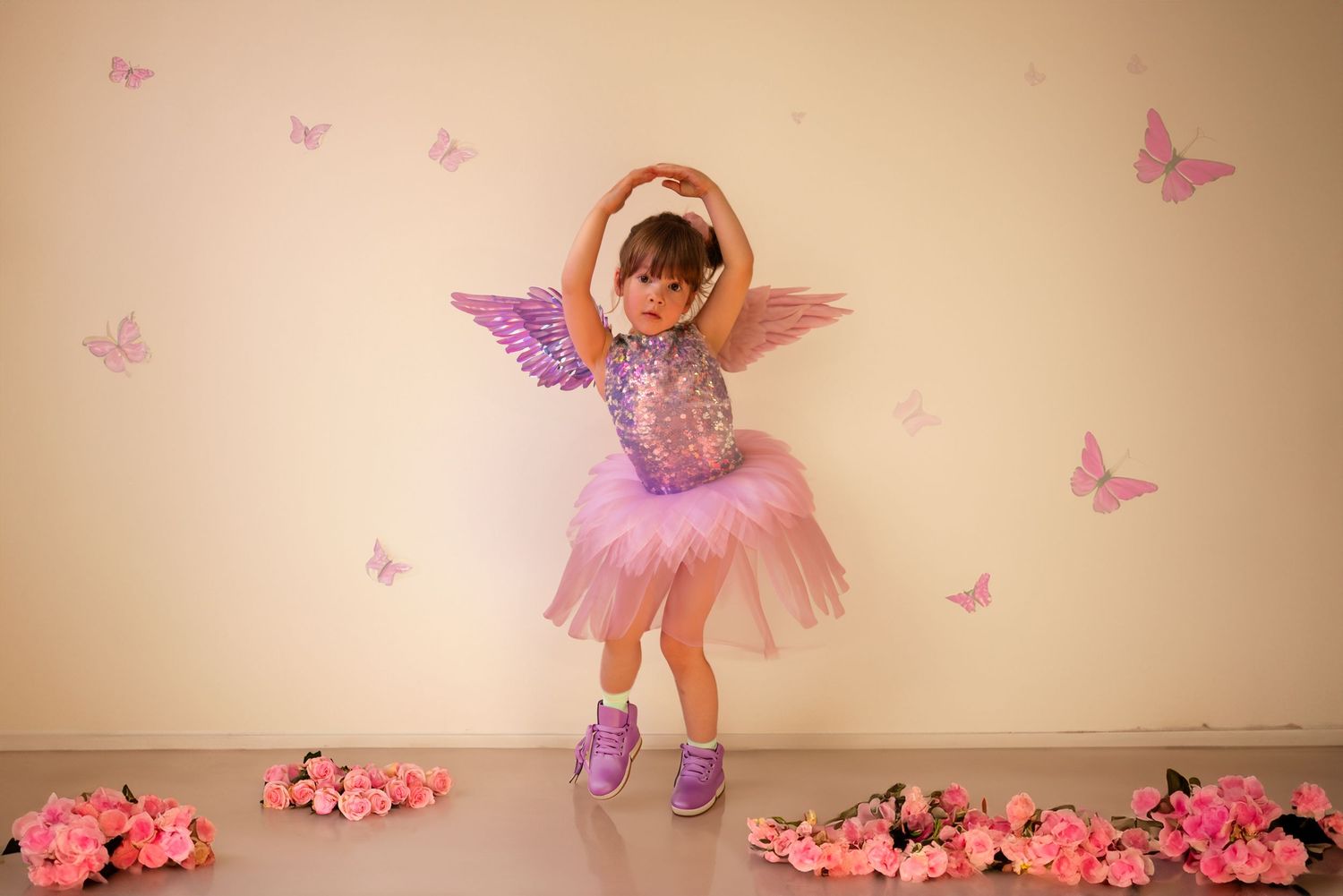 Scottsdale Portraits Pink and purple butterfly decorations adorn a light beige wall.