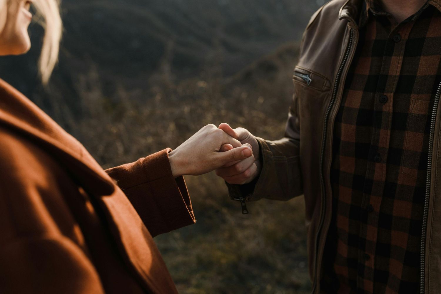 Surprise proposal in Flagstaff hills, couple glowing, red hat accent, photographed by premier Arizona engagement photographer.