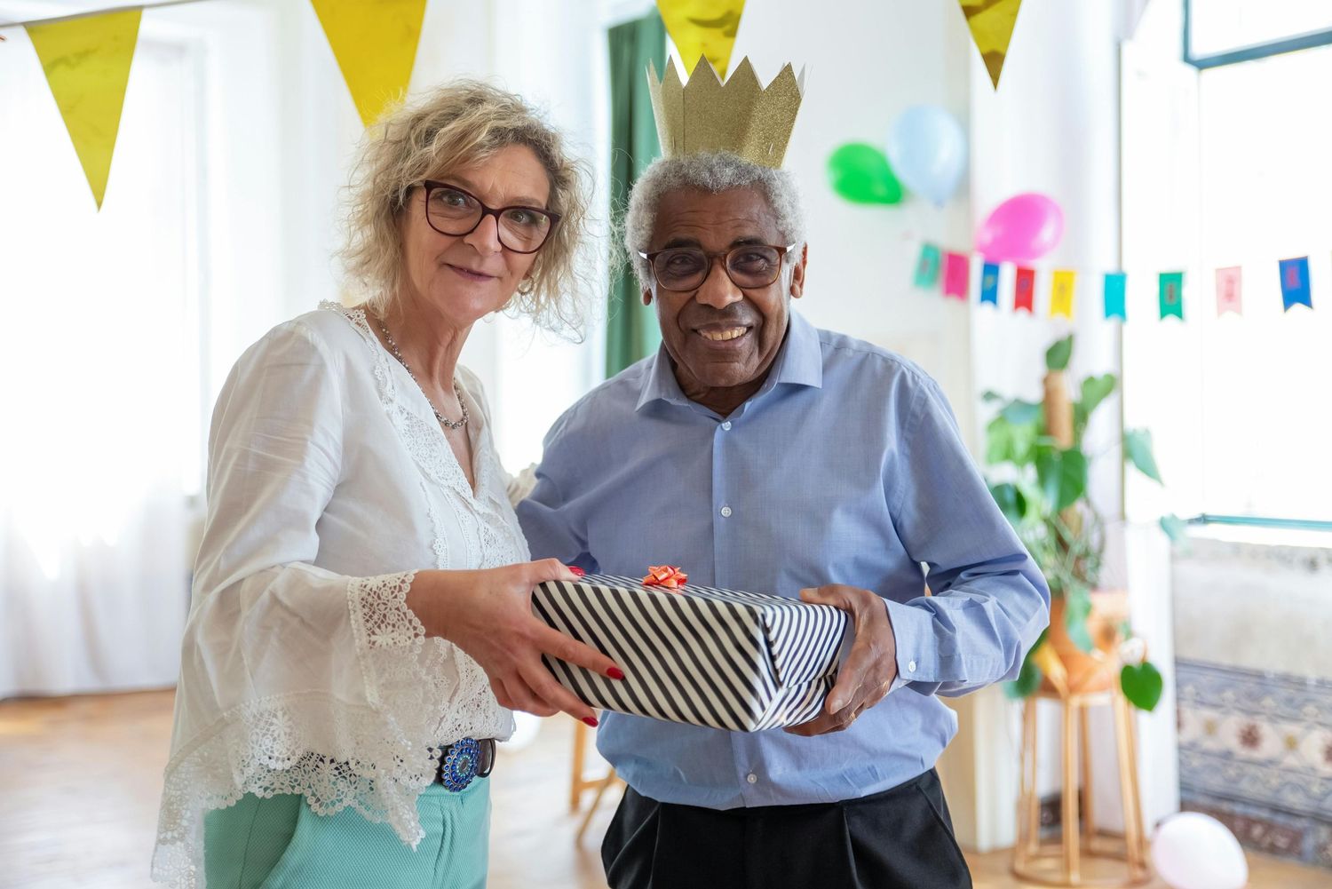 Two business colleagues share a laugh while working together in a bright office decorated with yellow banners.Arcadia Arizona.
