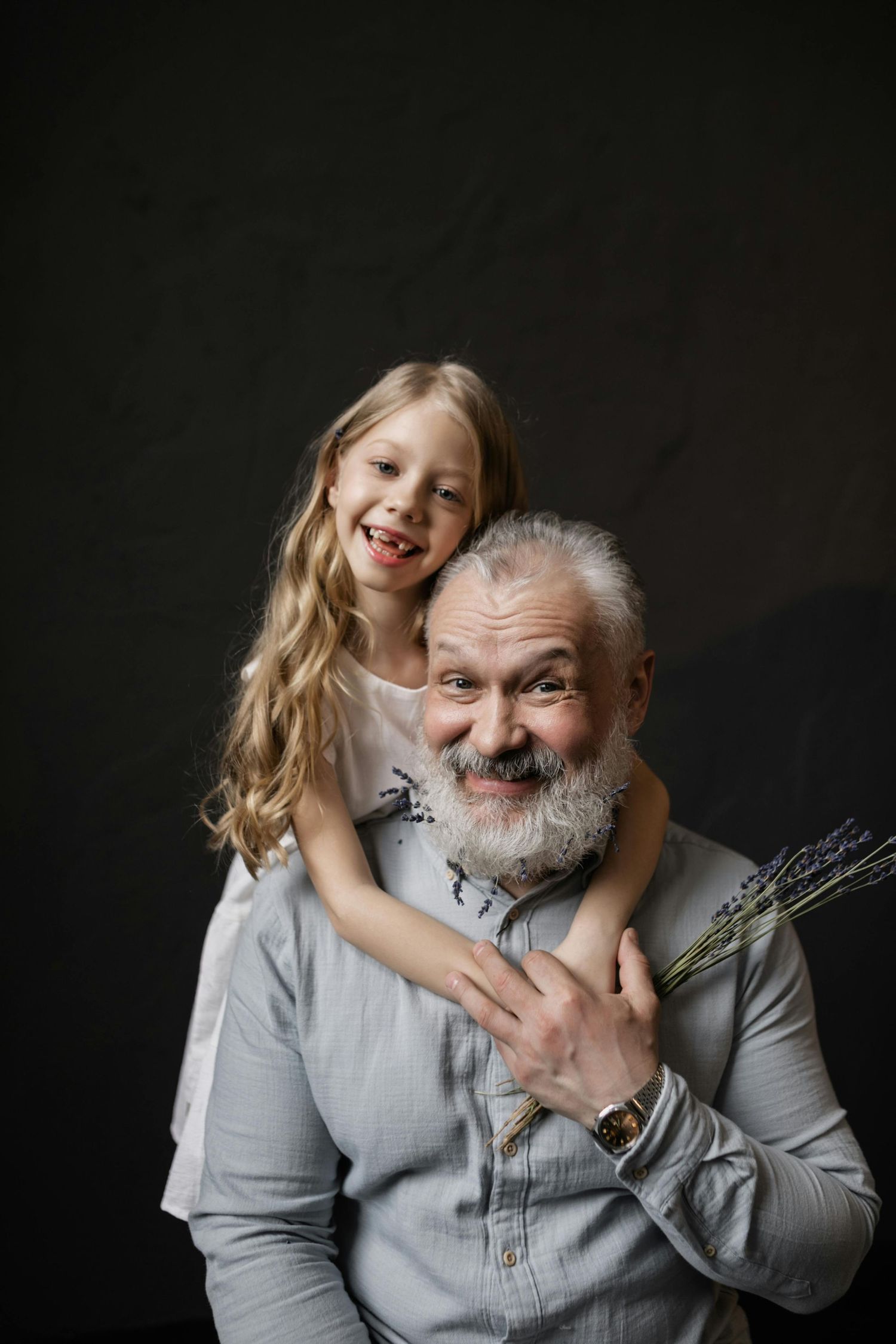 Flagstaff cozy indoor session, granddaughter laughing with grandpa, golden light, photographed by top Arizona family photographer.