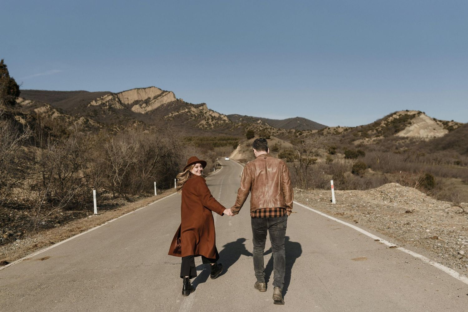 Flagstaff pine ridge, romantic moment, red hat accent, young couple, captured by top engagement photographer Arizona.