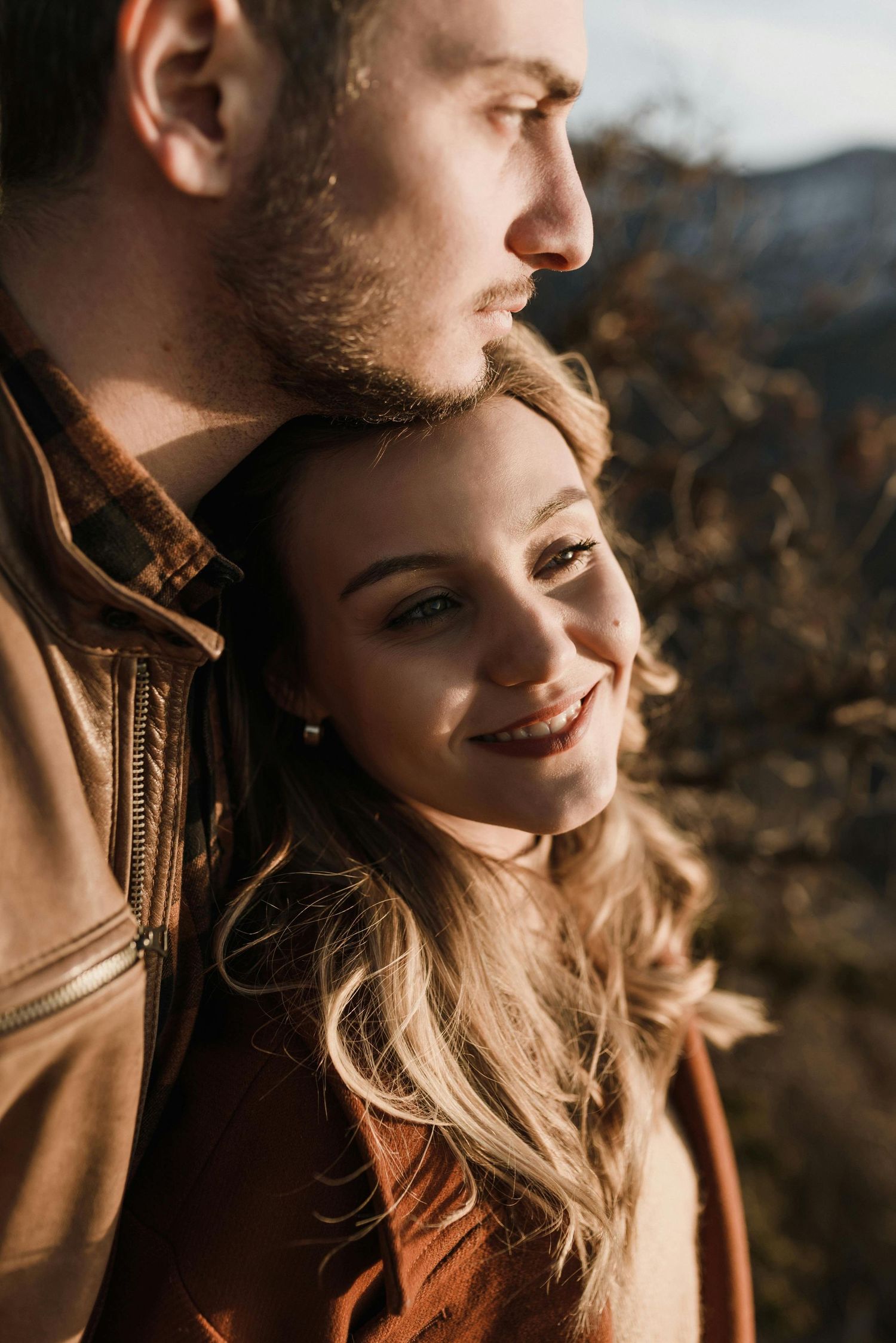 Young lovers’ engagement, red hat glowing, Kingman mountain views, photographed by premier engagement photographer Arizona.