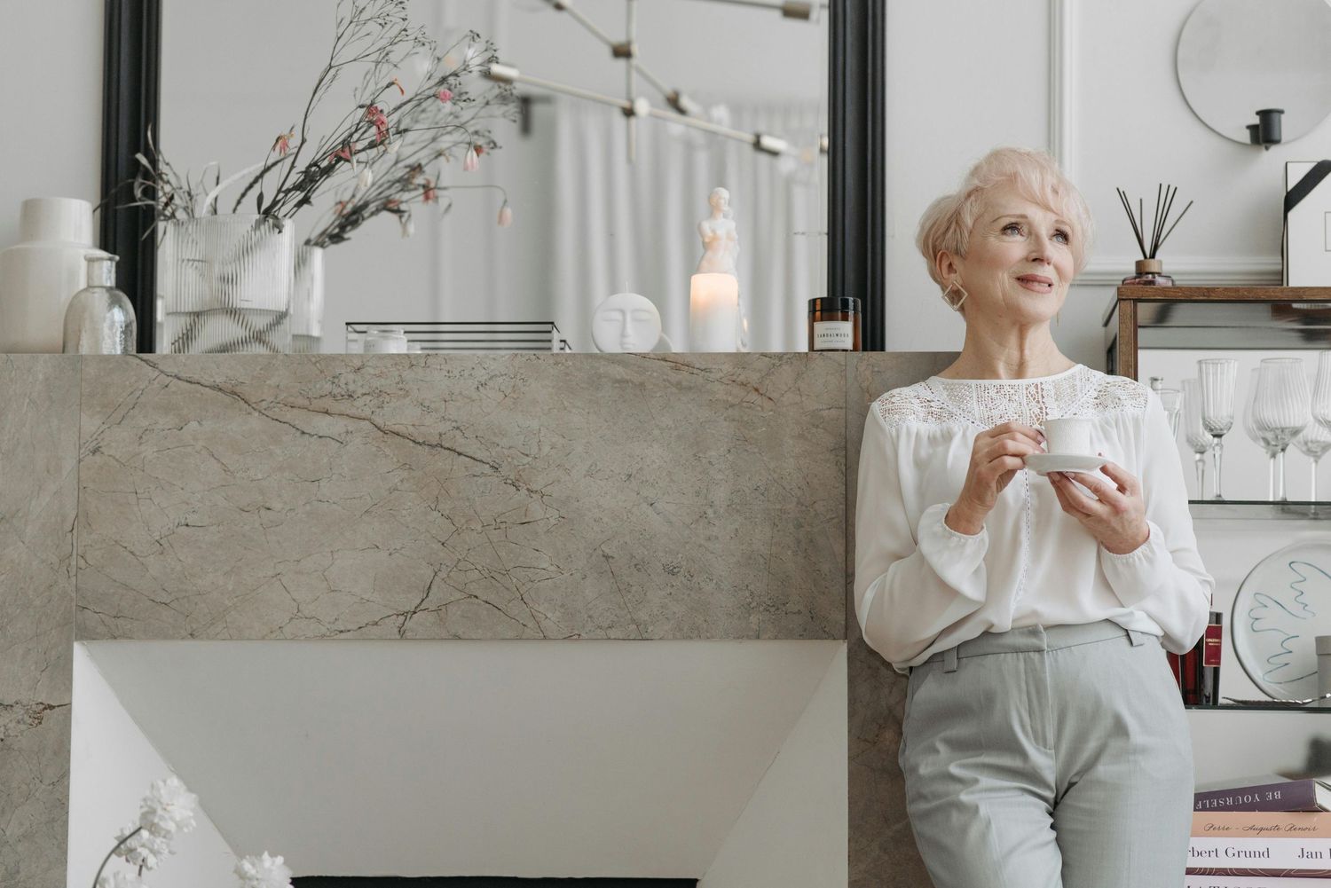 A series of modern interior design photos showing neutral-toned living spaces with minimalist decor and natural lighting.
