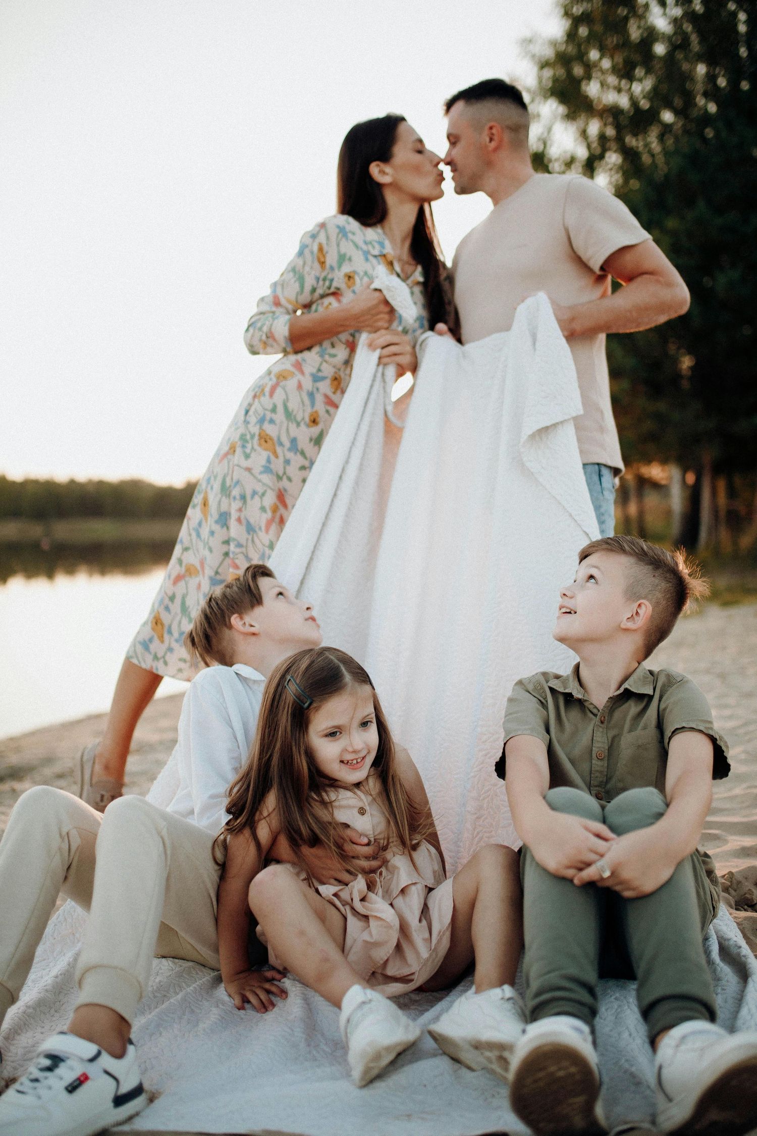 Prescott Arizona, mountaintop Family photography, Intimate family portrait session on a beach with casual poses and natural interactions.