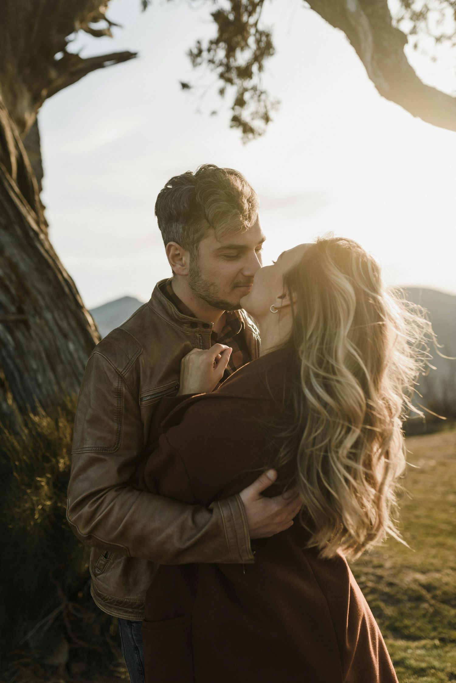Payson pine forest proposal, couple embracing, red-hatted woman, captured by top Arizona engagement photographer.