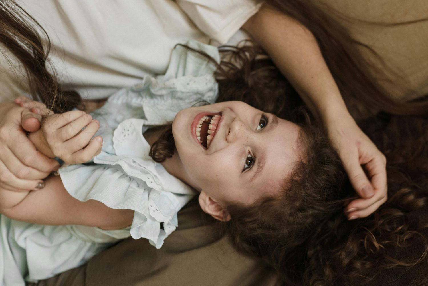 Tubac at-home family fun, warm natural tones, kids and parents enjoying playtime, captured as heirloom-quality portraits.