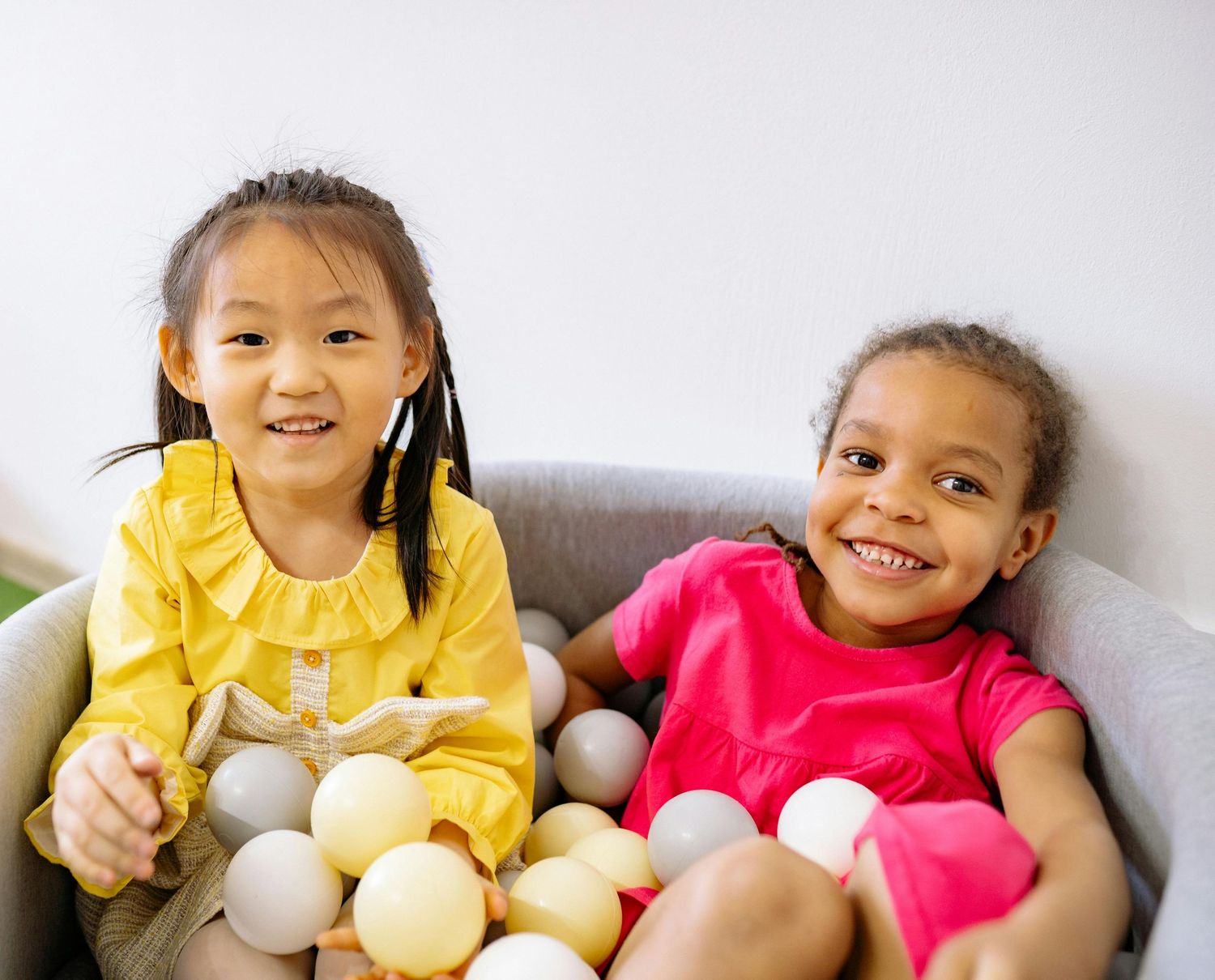 Chandler Arizona Daycare Photography Children sitting together on a couch during an educational activity.