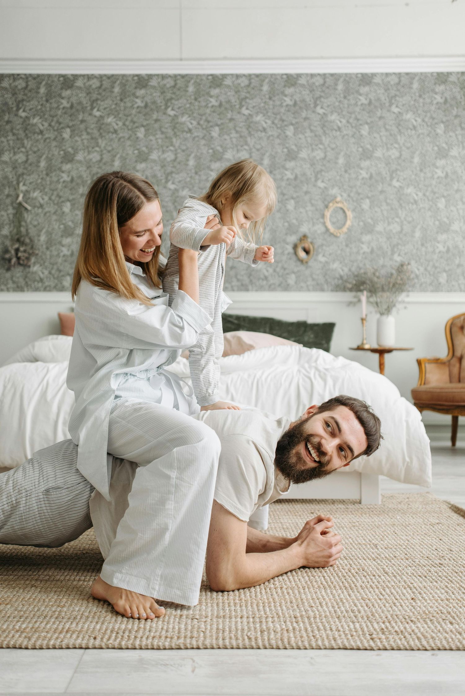 Parents tickling kids during cozy home portrait session, warm and luminous, photographed by Arizona’s premier family photographer.