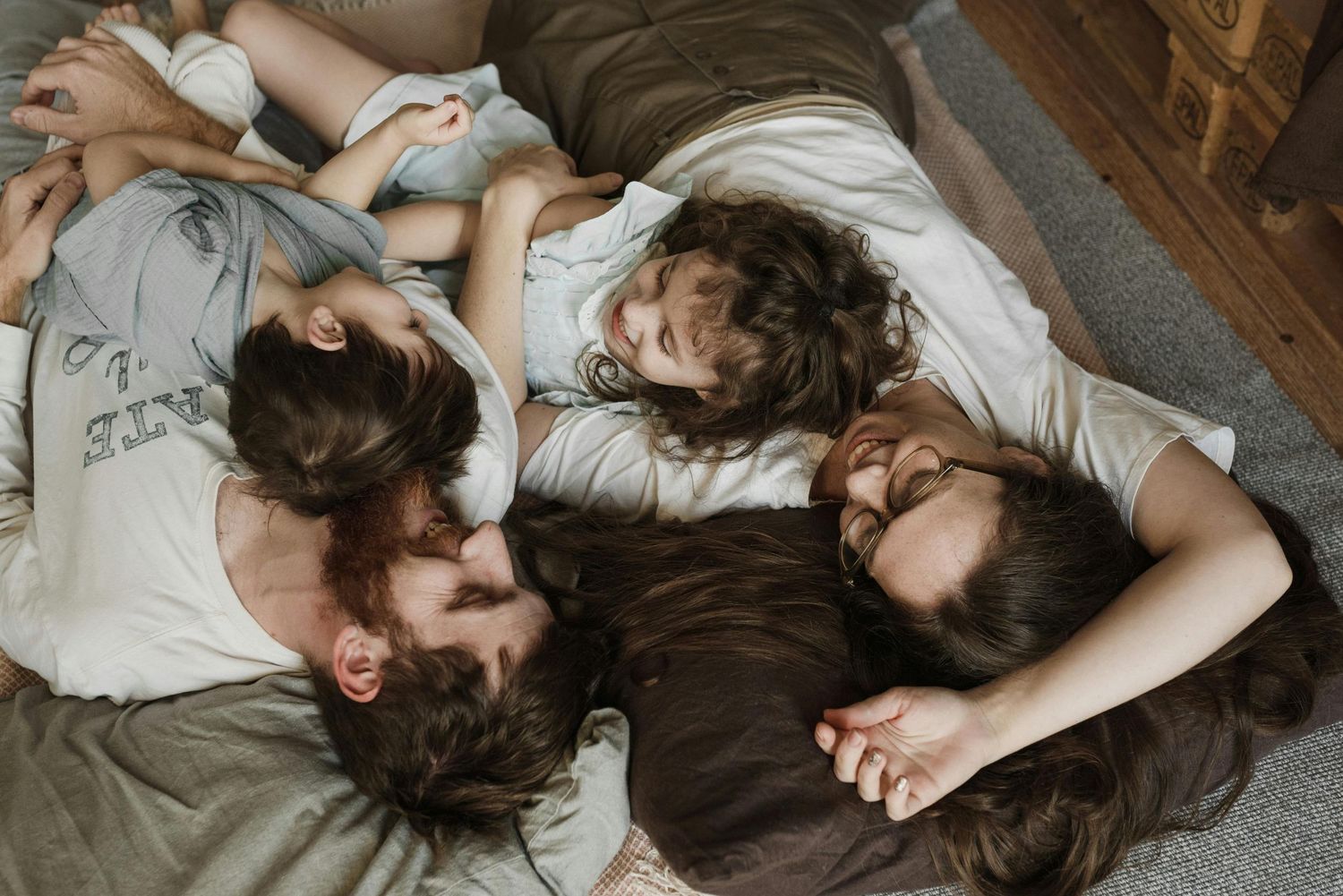 Patagonia cozy family moment, children hugging parents by the sofa, photographed as timeless keepsakes.