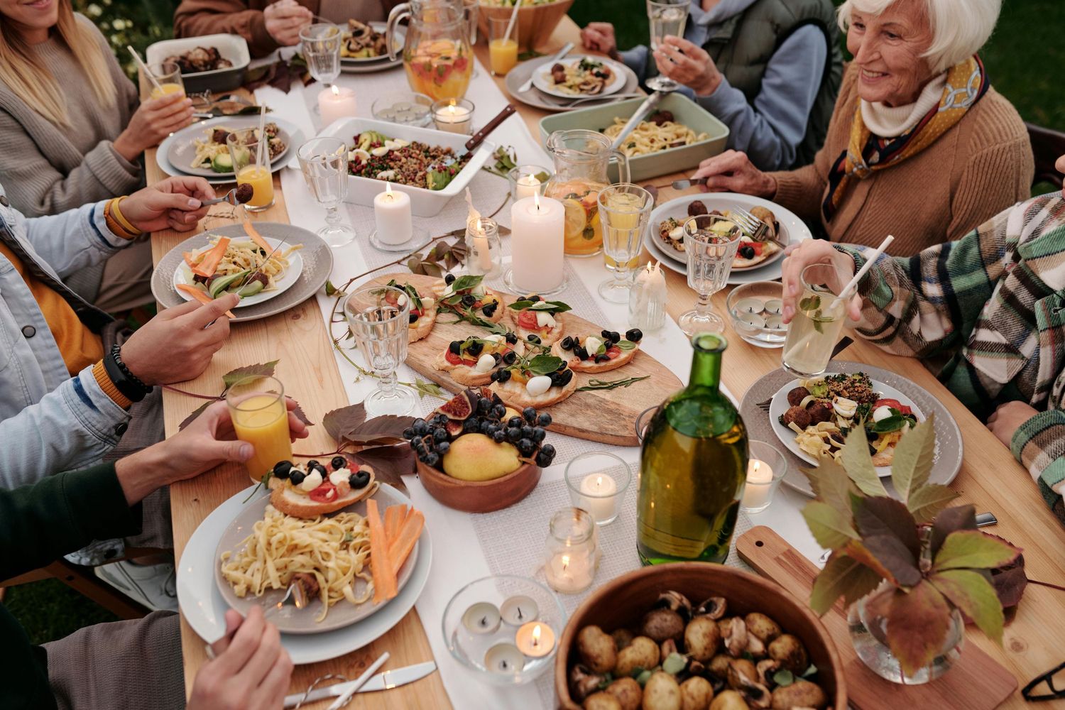 Senior Photography Sedona. festive dinner table spread with plates of food, wine bottles, and candles.