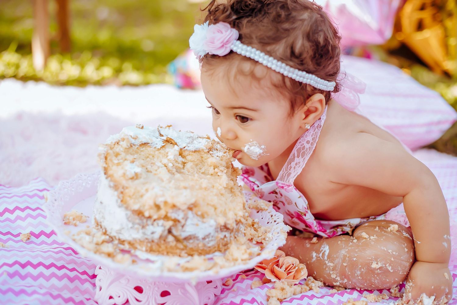 Sedona smash cake portrait, joyful toddler enjoying cake, warm light, captured by Arizona luxury photographer