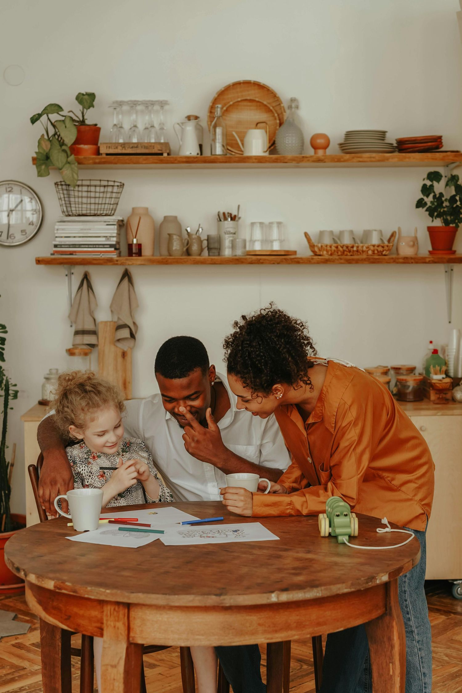 Family gathered in living room, children giggling, parents smiling, captured by luxury Arizona family photographer for lasting memories.