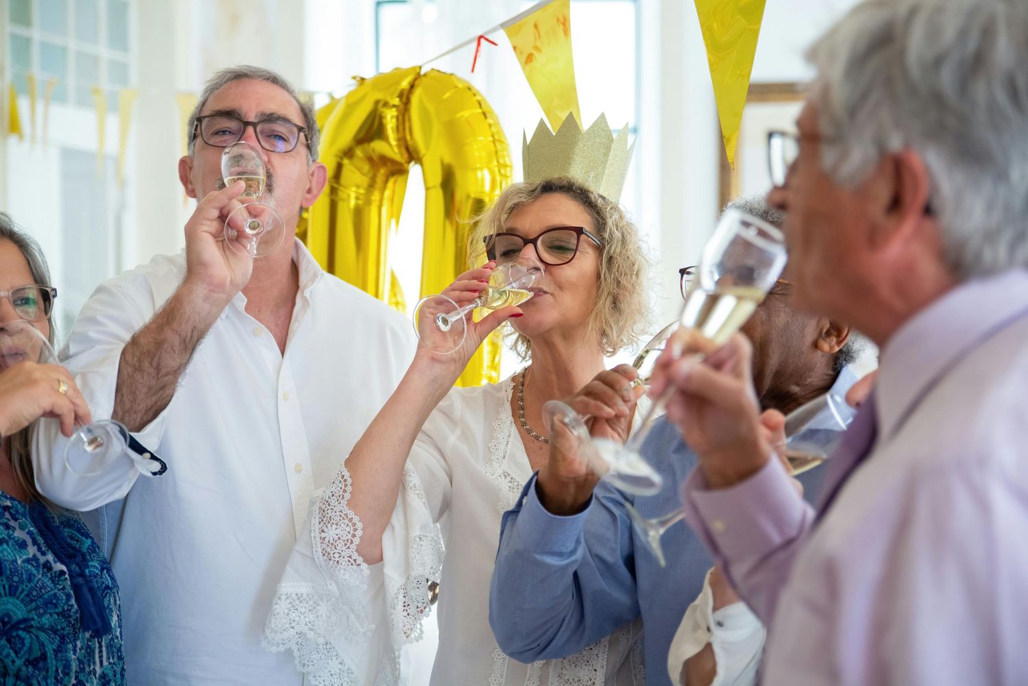 Arizona Photographer. Party celebration with yellow pennant decorations and people blowing party horns.