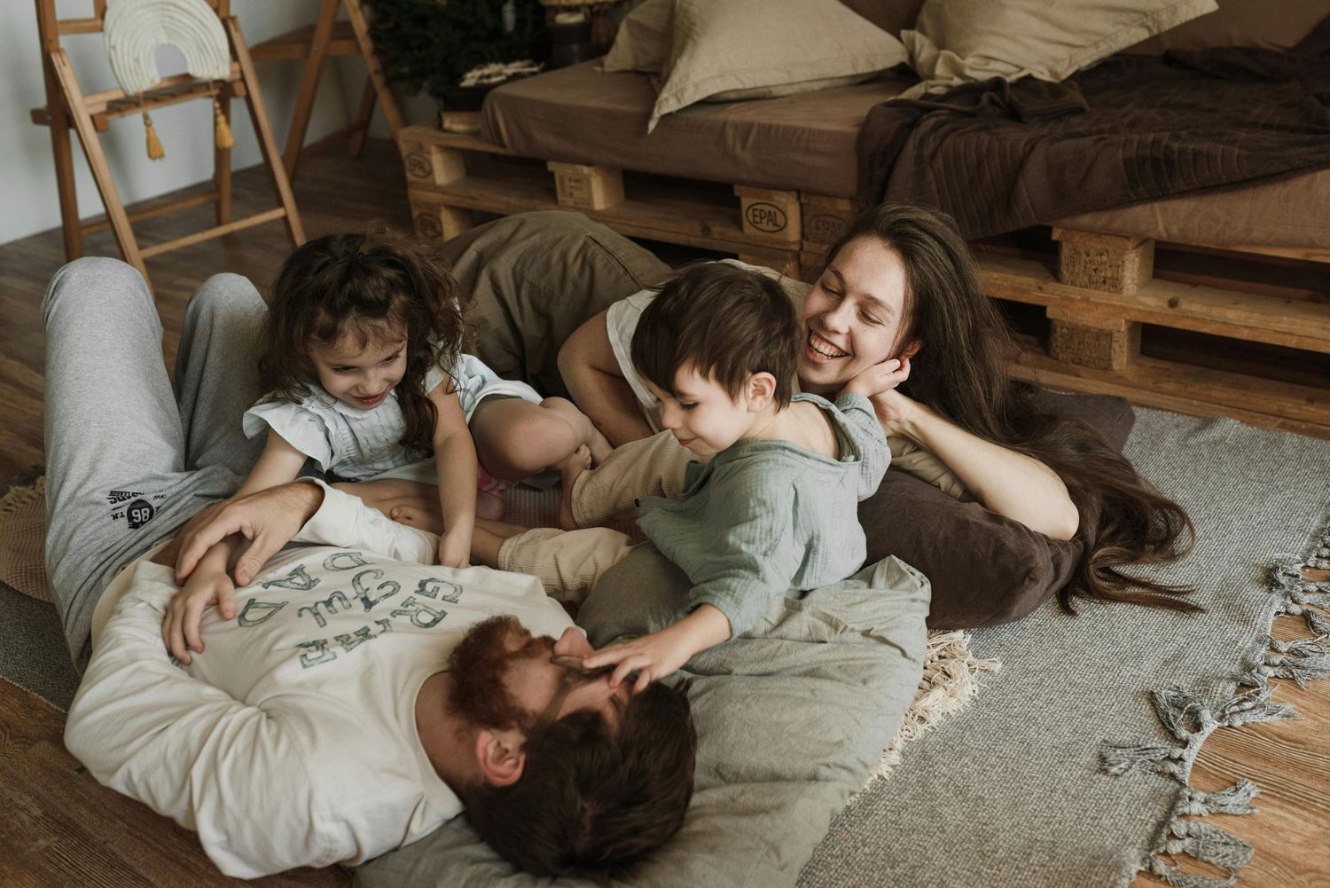 Bisbee, Arizona warm indoor family portrait, parents embracing children, fine-art photography to treasure for generations.