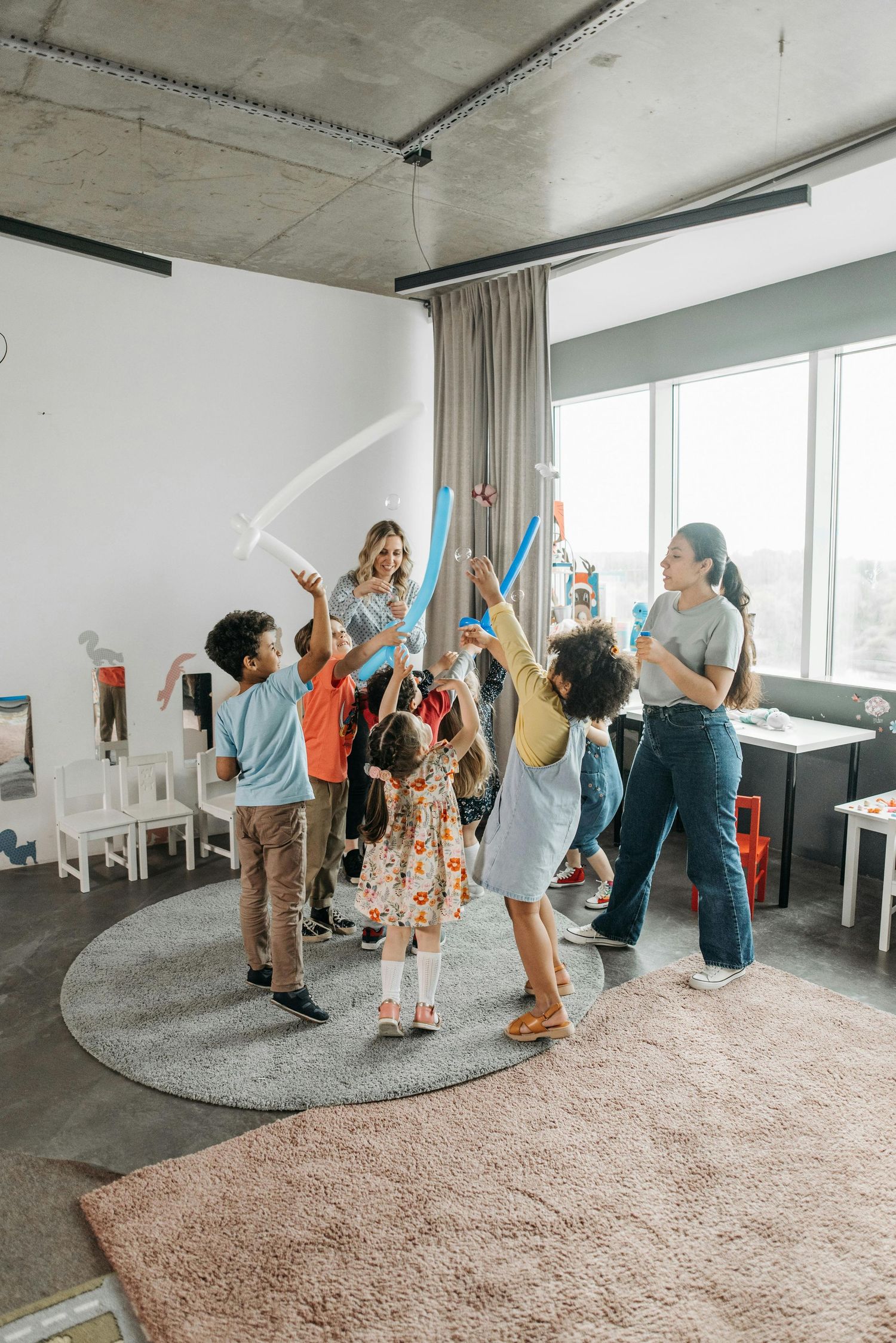 Arizona Daycare Photography People participating in group exercise or dance activity in modern room with windows.
