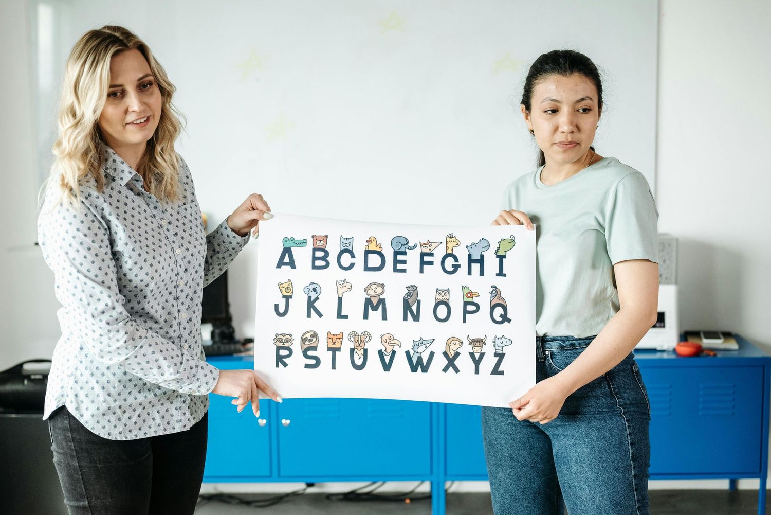 Scottsdale Arizona Photography Students learning the alphabet with educational materials displayed on blue tables.