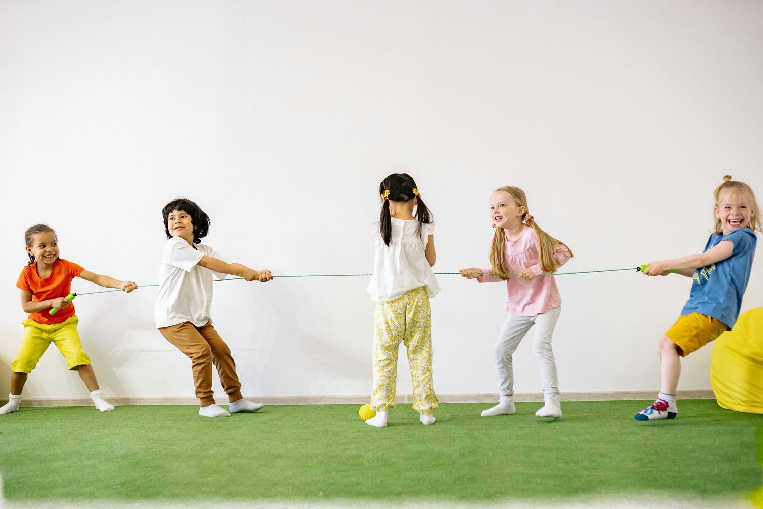 Queen Creek  Arizona Daycare Photography Group of students playing and learning in a bright indoor educational space.