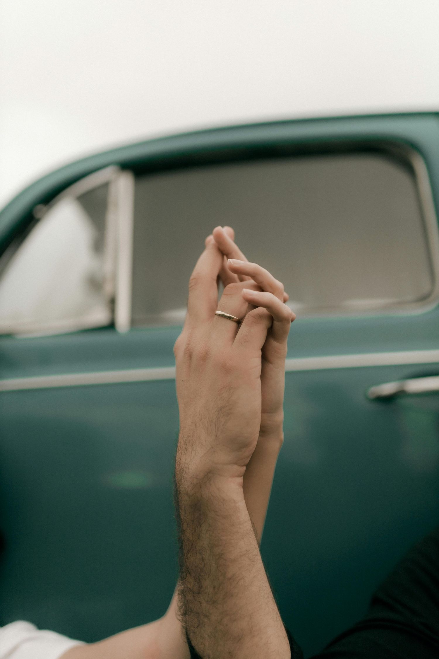 A hand gestures against a blurred vintage car background in a series of progressive movements. Best Photographer Phoenix.