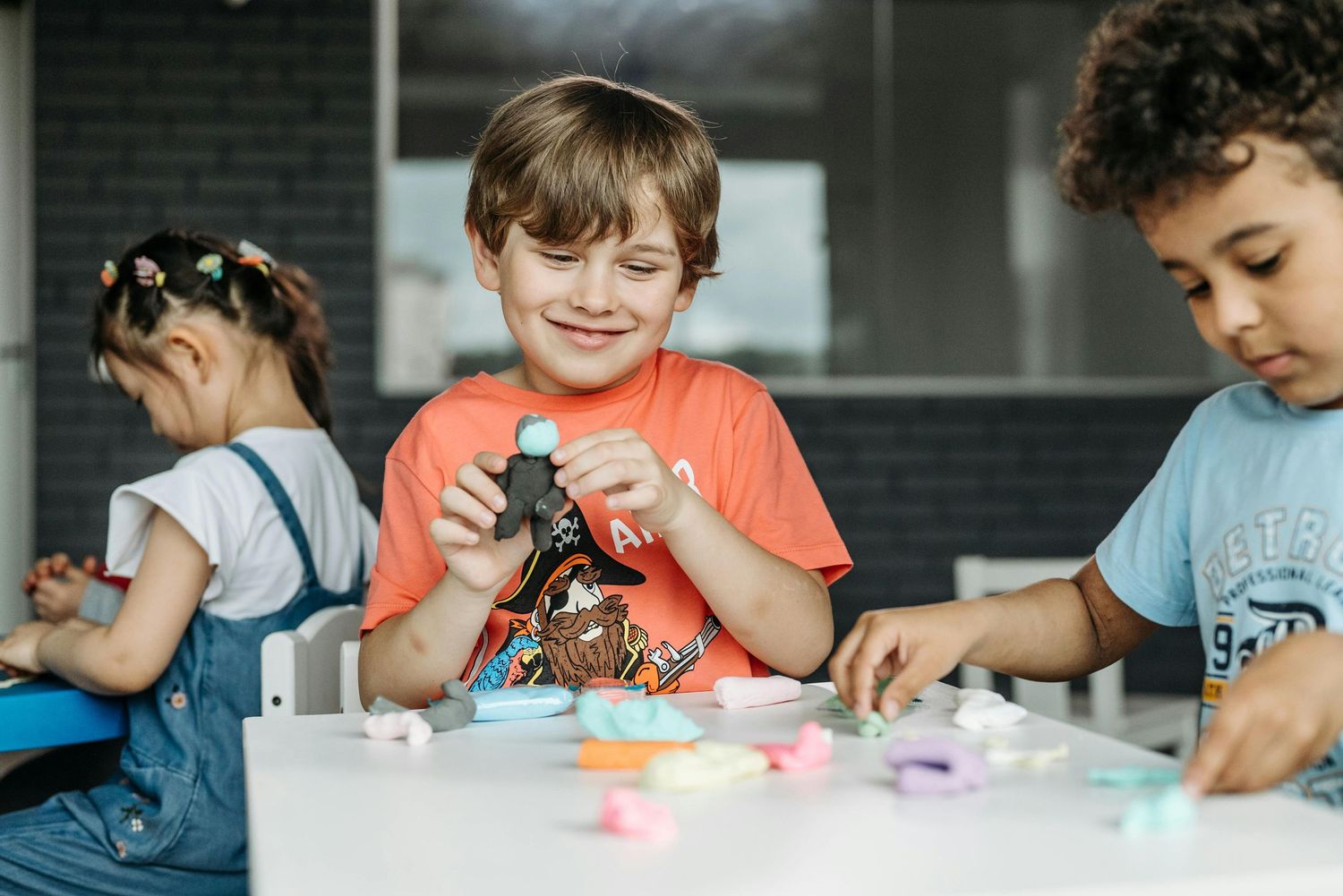 Scottsdale Arizona Photography Children working on creative projects with colorful materials at a table.
