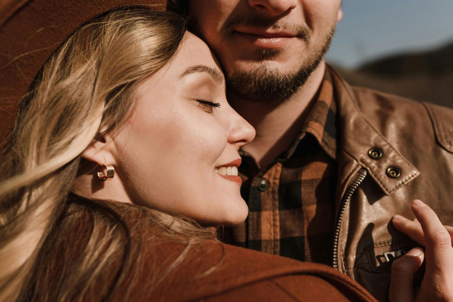 Jerome cliffs engagement, young lovers, red hat elegance, captured by Arizona’s luxury engagement photographer.