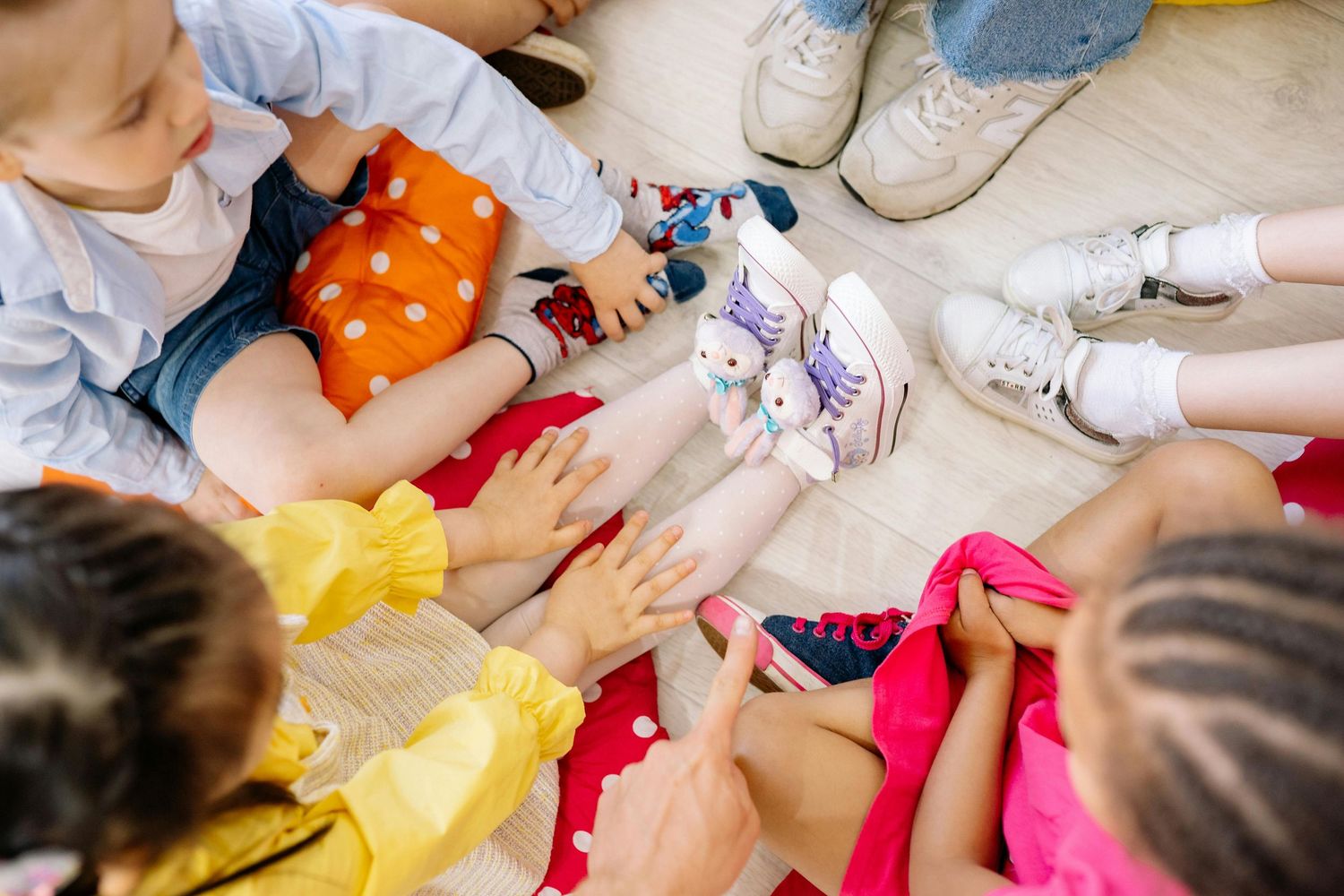 Queen Creek  Arizona Daycare Photography Students engaged in floor activities with colorful learning materials.