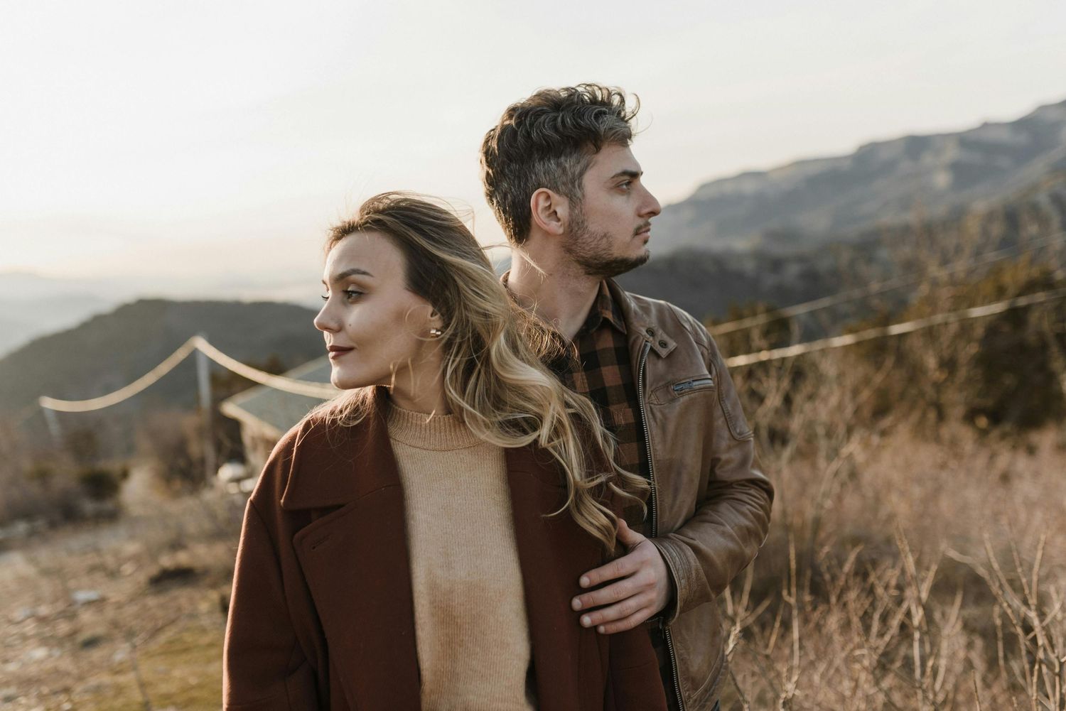 Loving couple atop Prescott peaks, red hat elegance, intimate engagement, shot by finest engagement photographer Arizona.