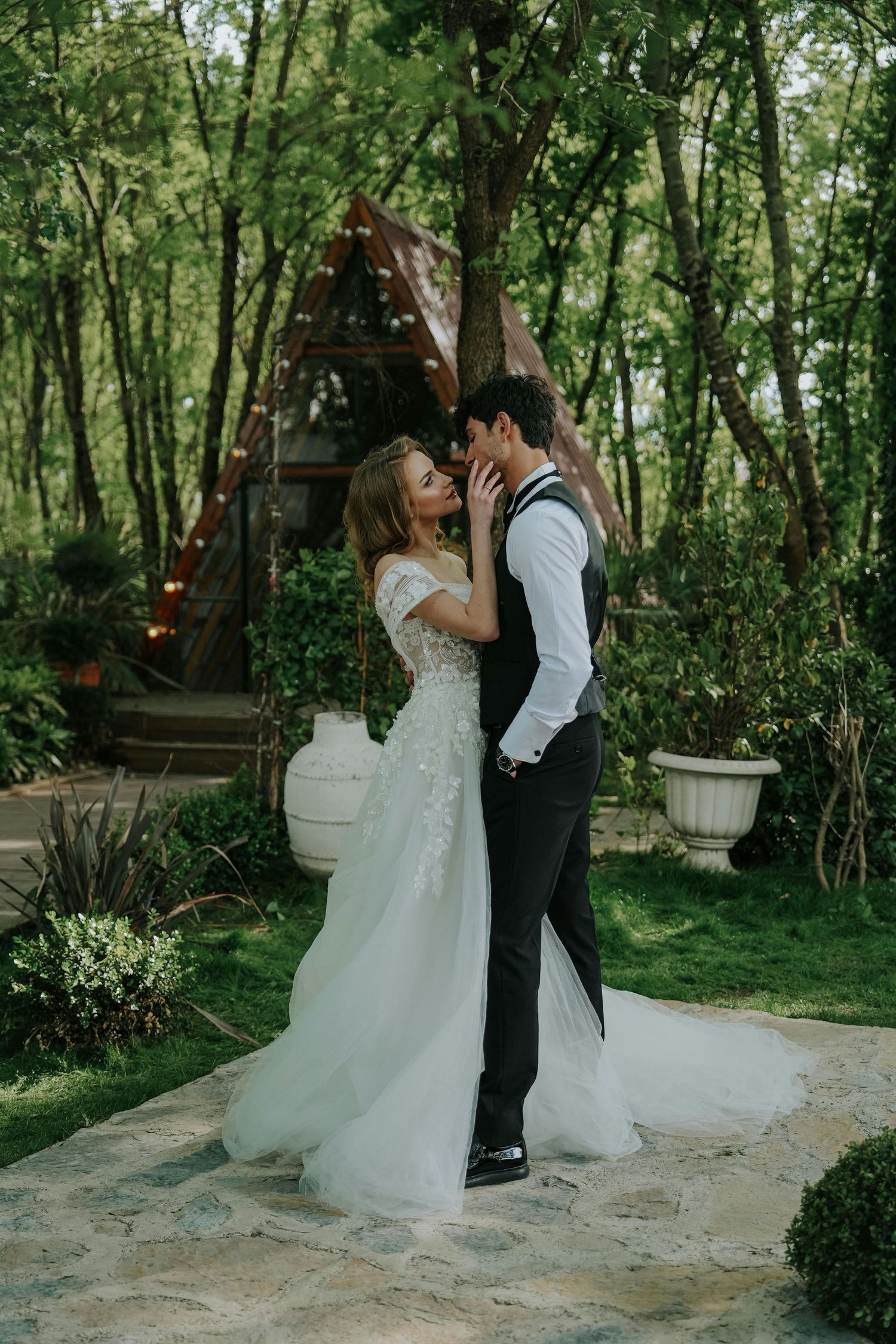 A romantic wedding photoshoot in a lush green garden setting with stone pathways. Leading Arizona Photographer.