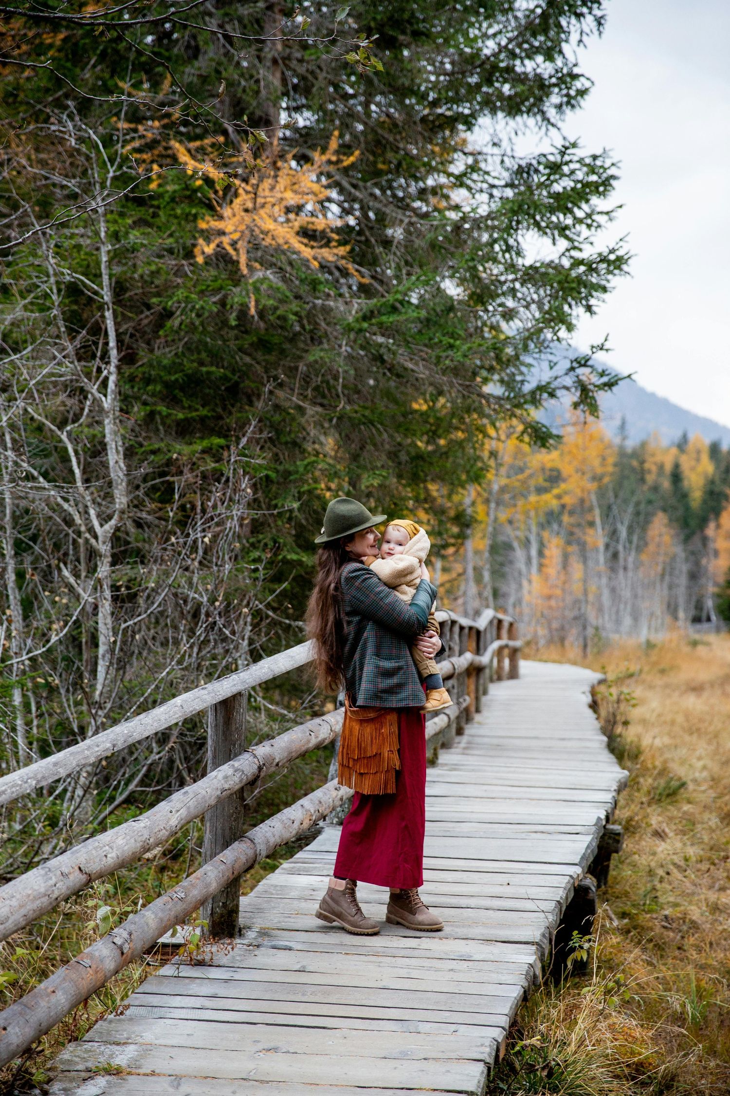 Sedona Arizona Portraits Scenic wooden boardwalk through autumn mountain landscape with evergreen trees and fall colors.