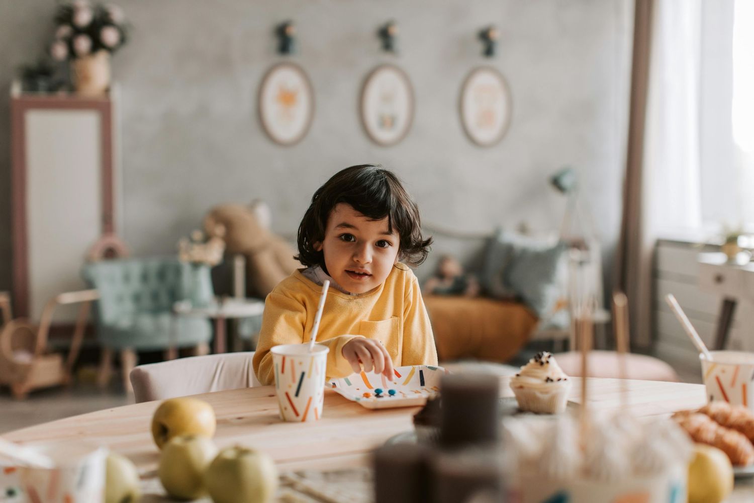 Phoenix birthday bash, kids blowing candles, playful smiles, captured by top Arizona children photographer.