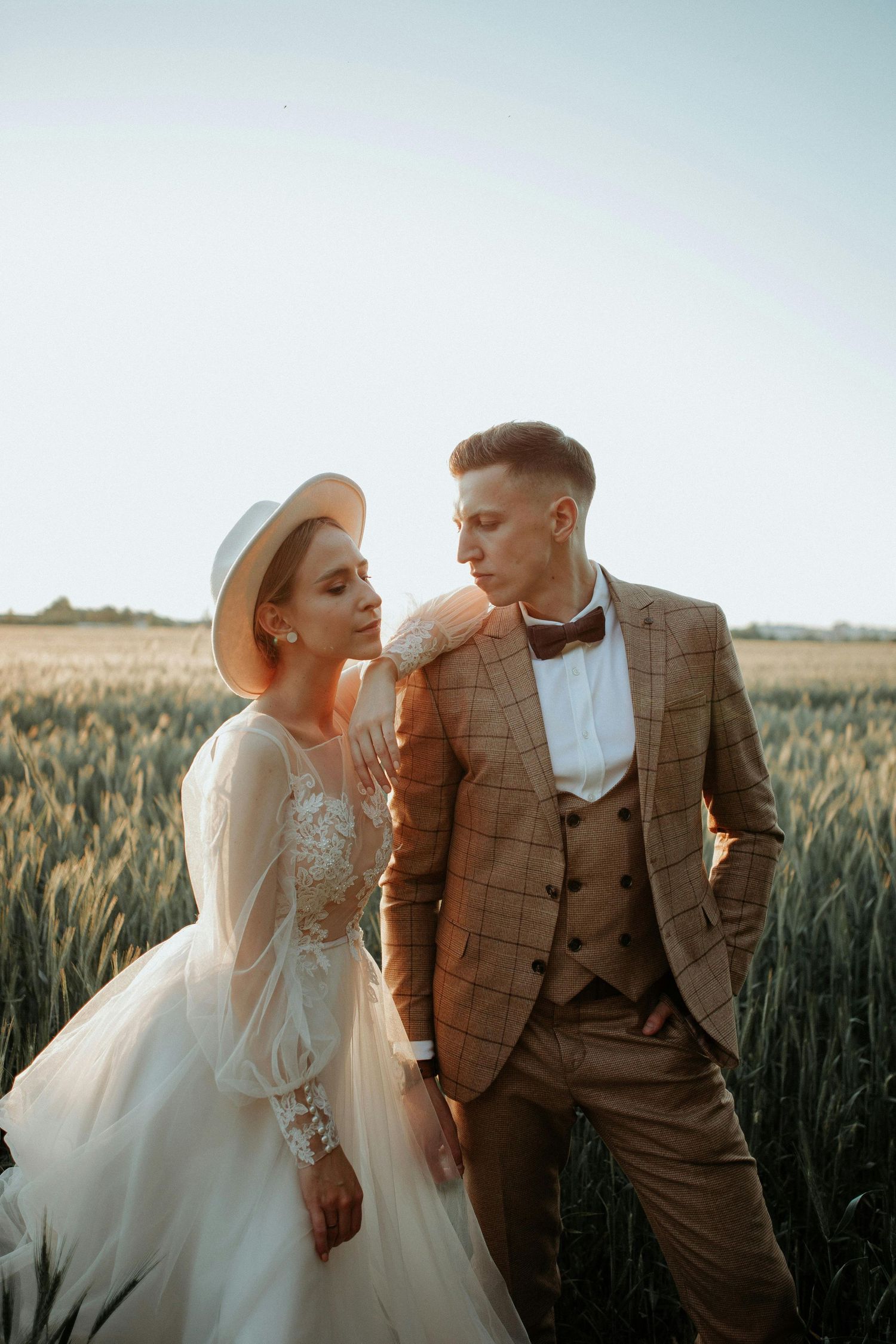 Elegant wedding portraits captured in a rustic wheat field with couple in formal attire. Trusted Sedona Photographer.