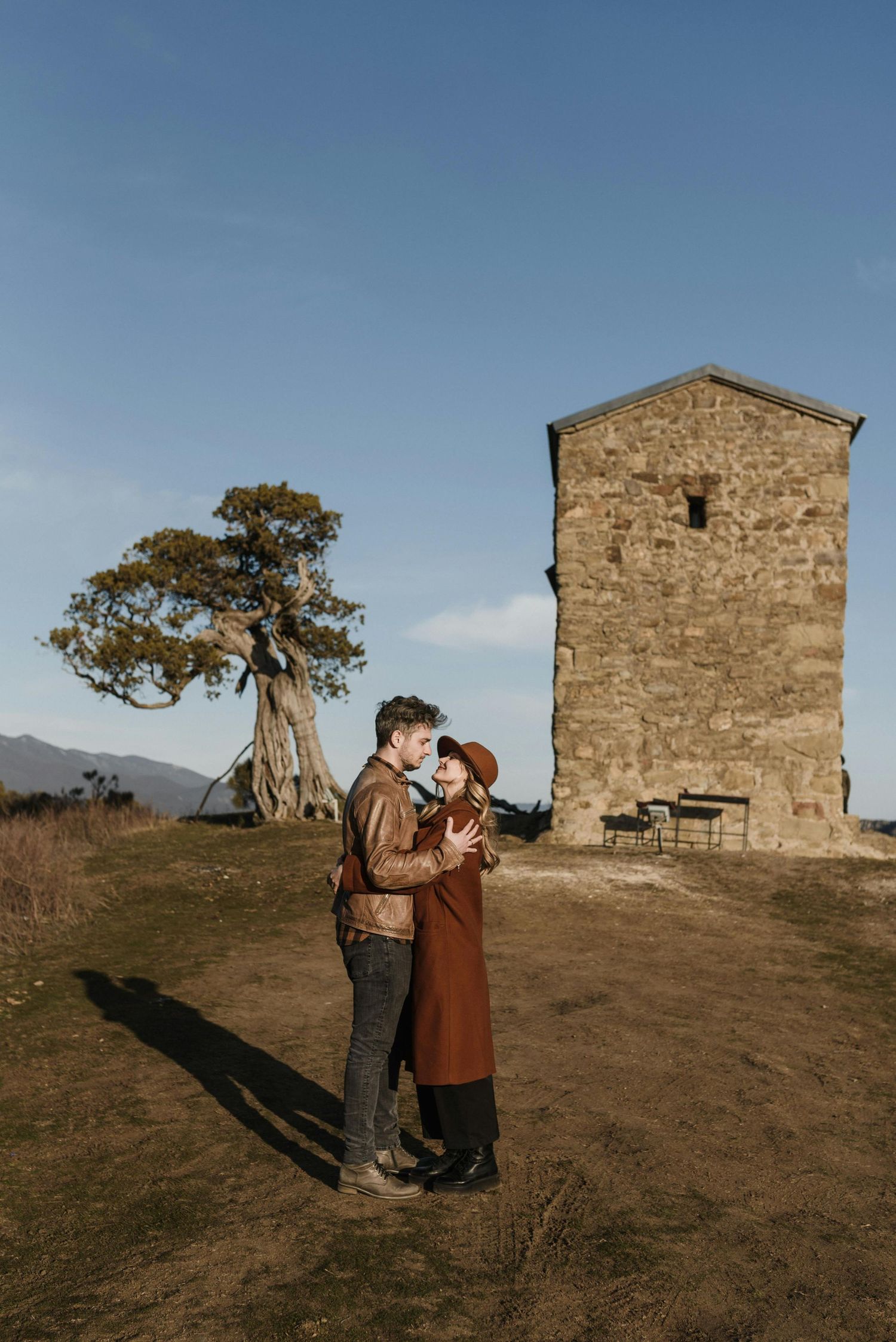 Flagstaff forest surprise engagement, warm sunlight, red hat, young couple, photographed by Arizona’s finest engagement photographer.