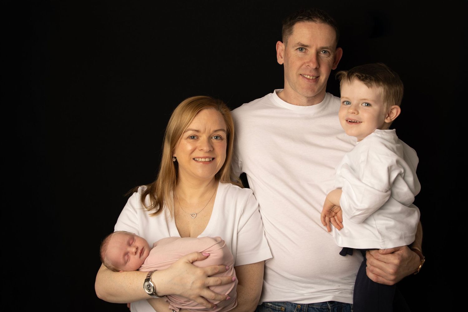 Family of four photographed with their newborn baby in Cork photoshoot