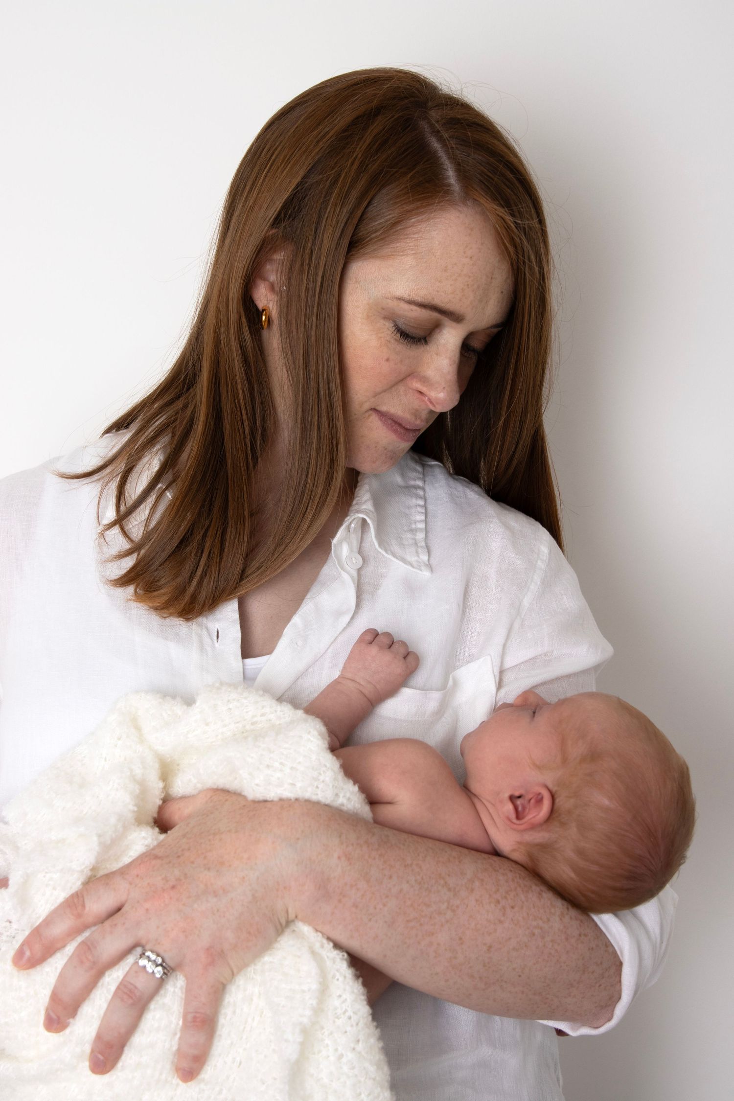 Mother holding her newborn baby during a newborn photography session in Tower Cork