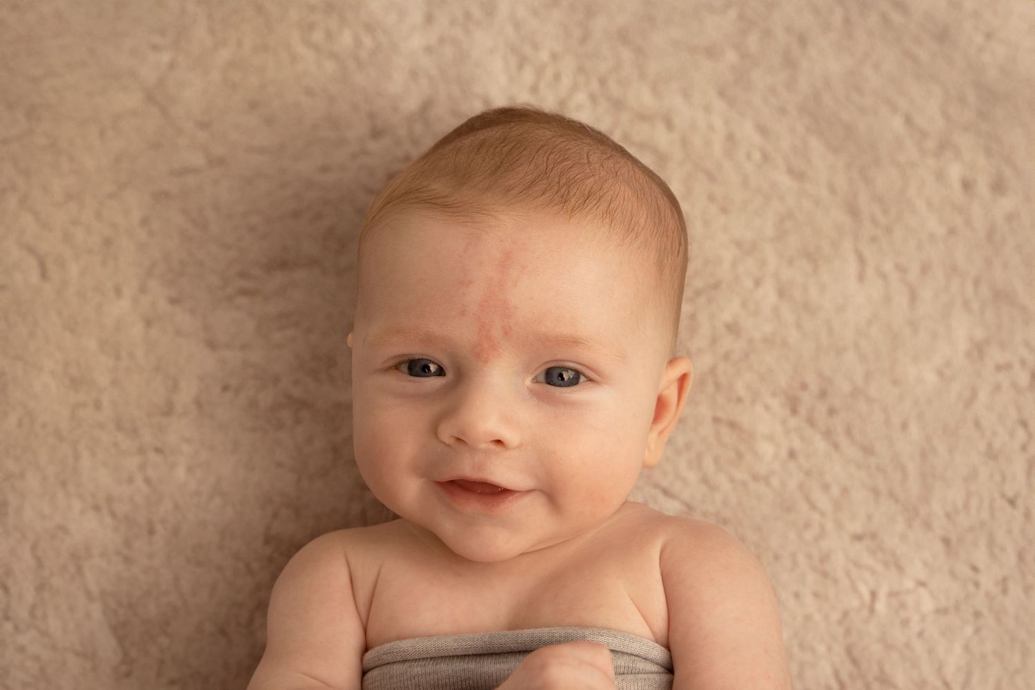 Image of smiling little baby during newborn shoot