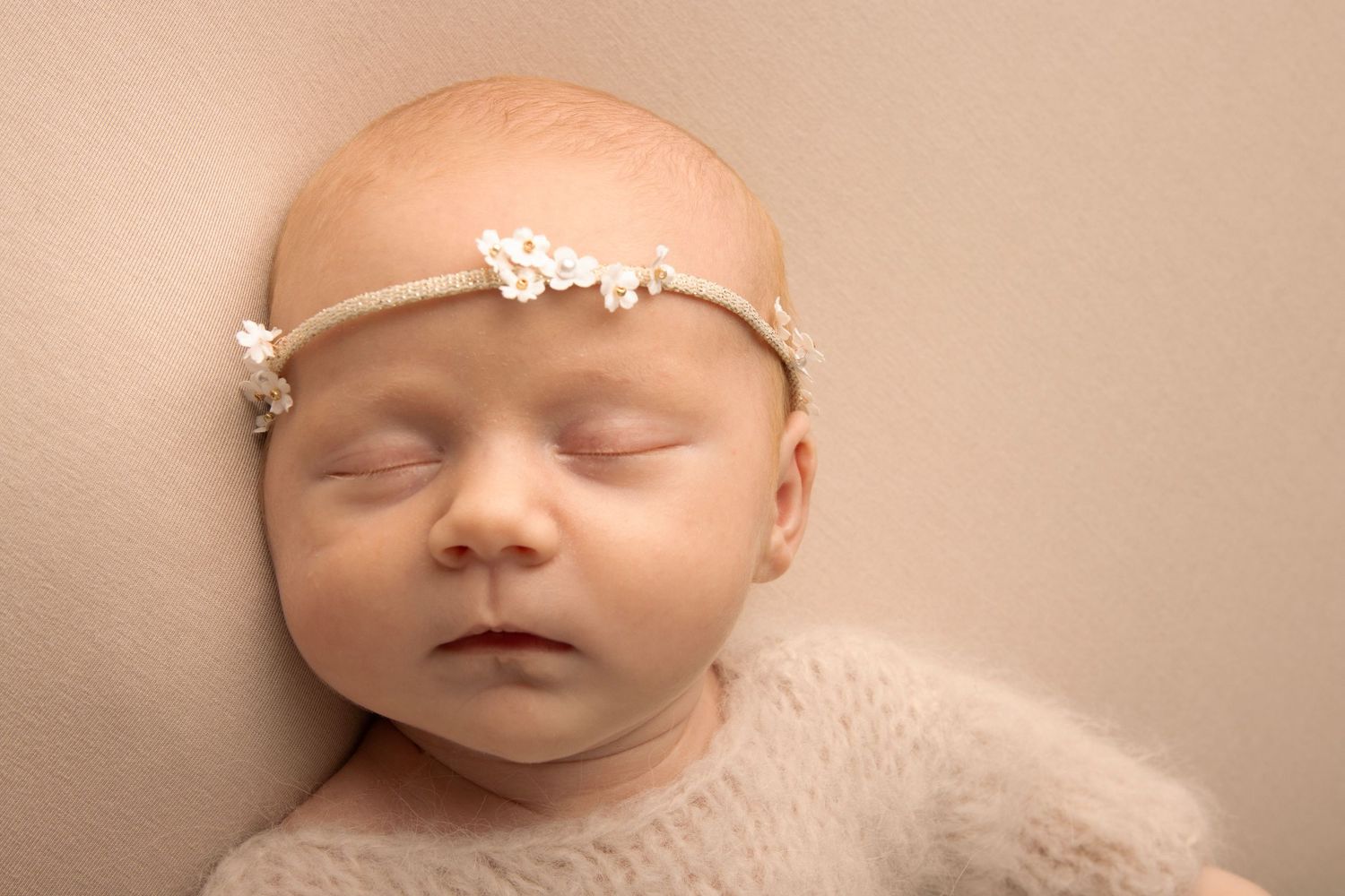 Sleeping baby wearing floral headband during a newborn photography session in Tower Co. Cork