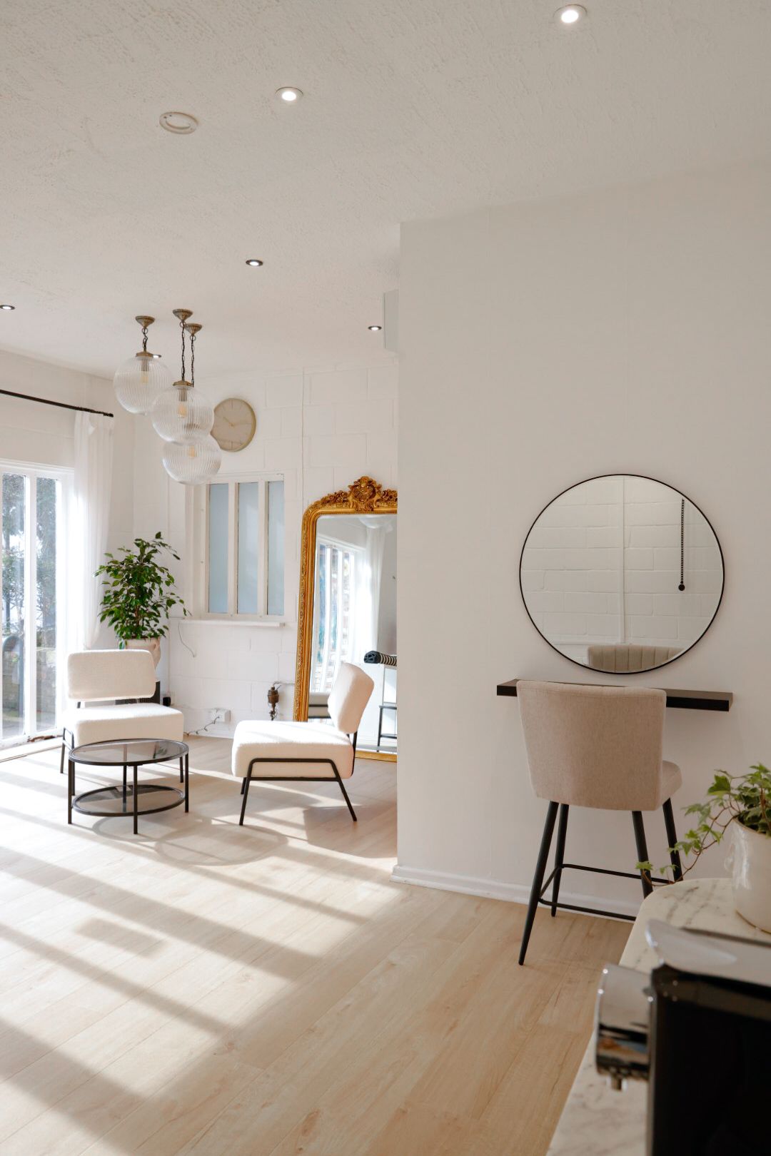 Bright minimalist photography studio interior with natural light and modern furniture.