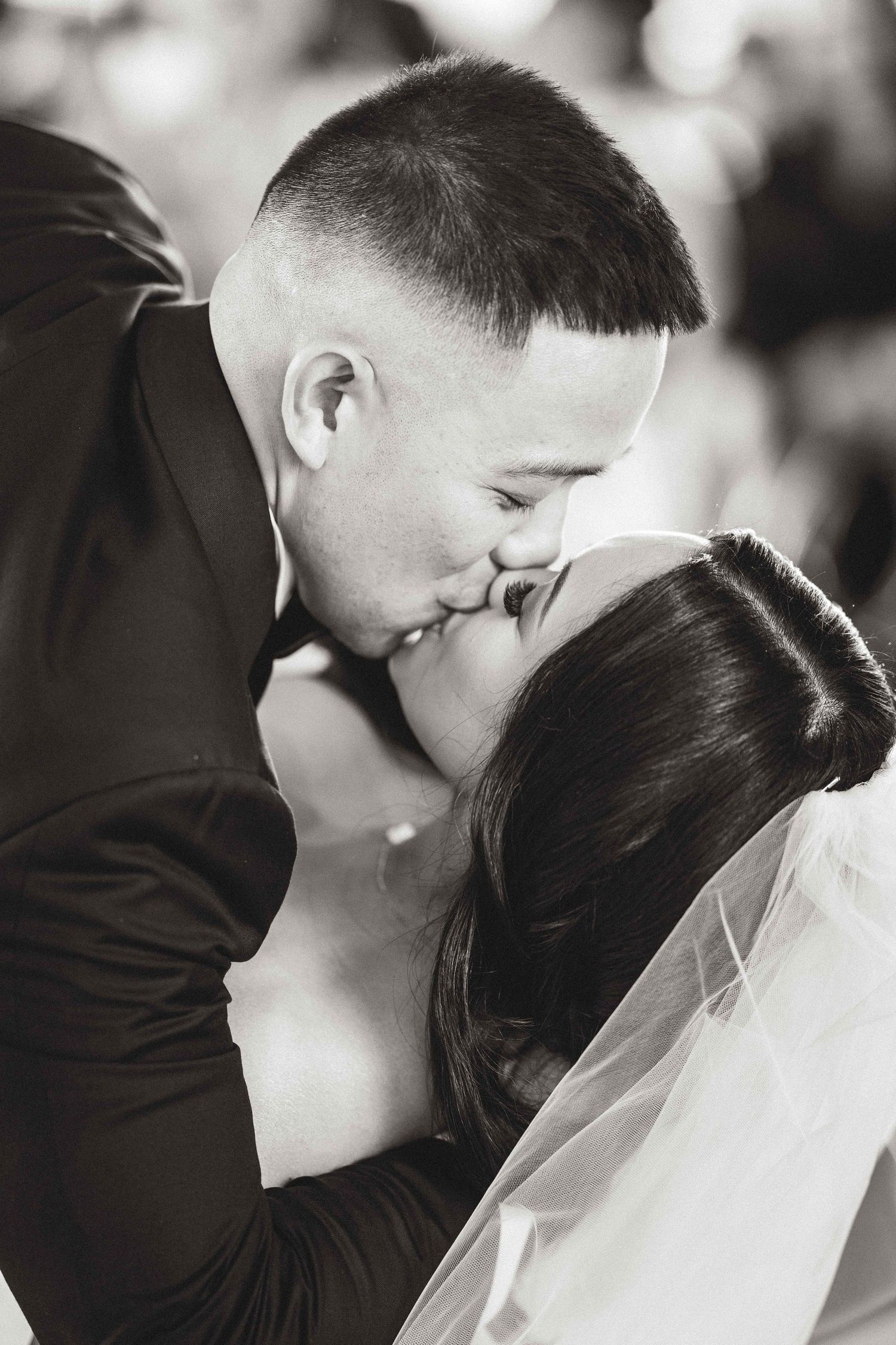 Romantic black and white wedding photo series showing tender kiss moments between bride and groom.