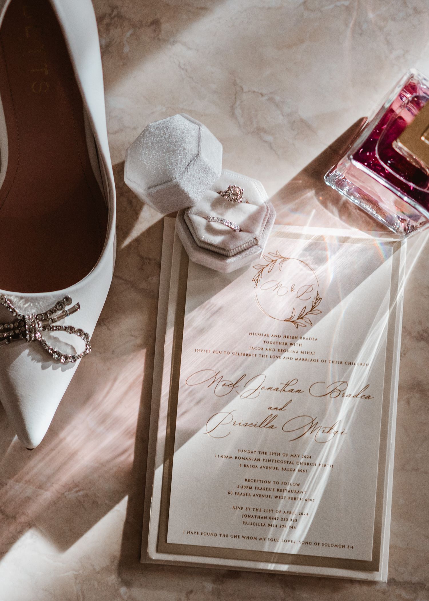 Elegant wedding invitation suite with white shoes and delicate details.