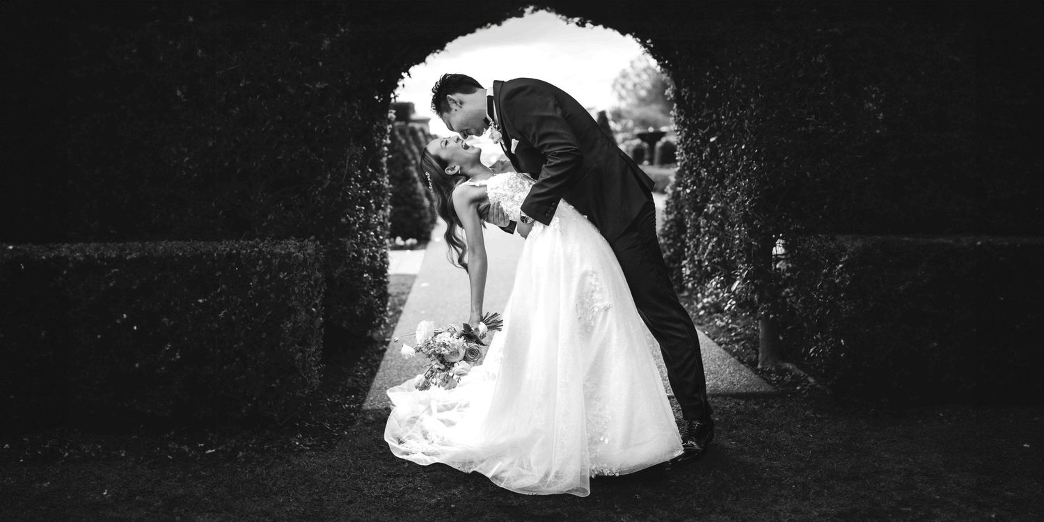 A romantic wedding dance sequence captured in dramatic black and white photography.