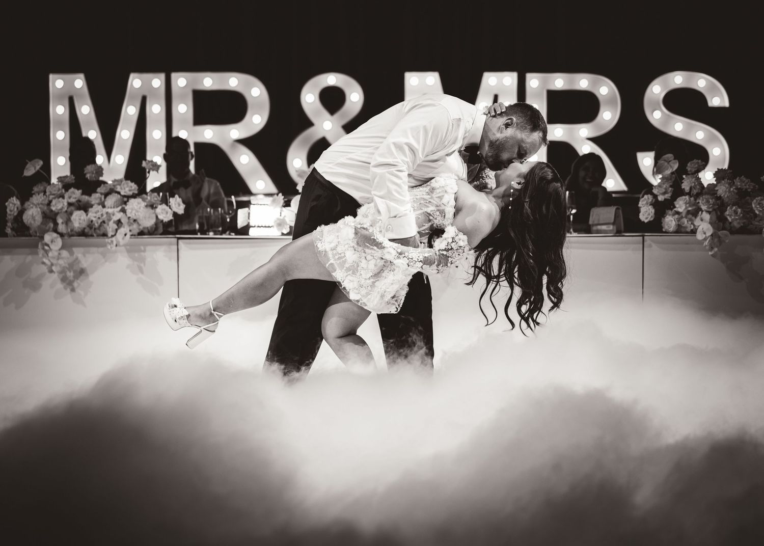 Black and white reception dance photos with Mr & Mrs sign and fog effects.